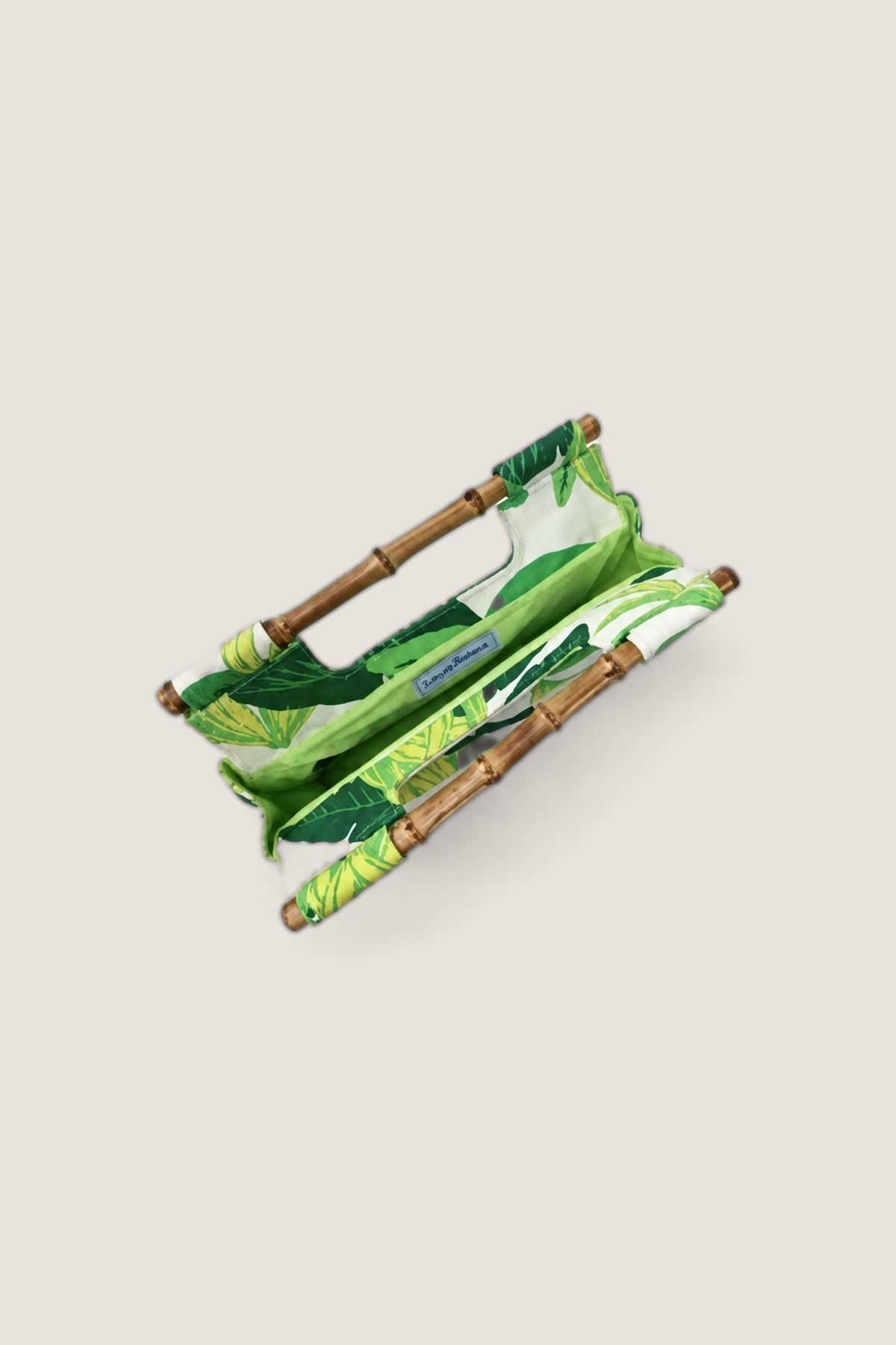 The Banana Bamboo Clutch opened from above, showing its green lining and the two bamboo handles.