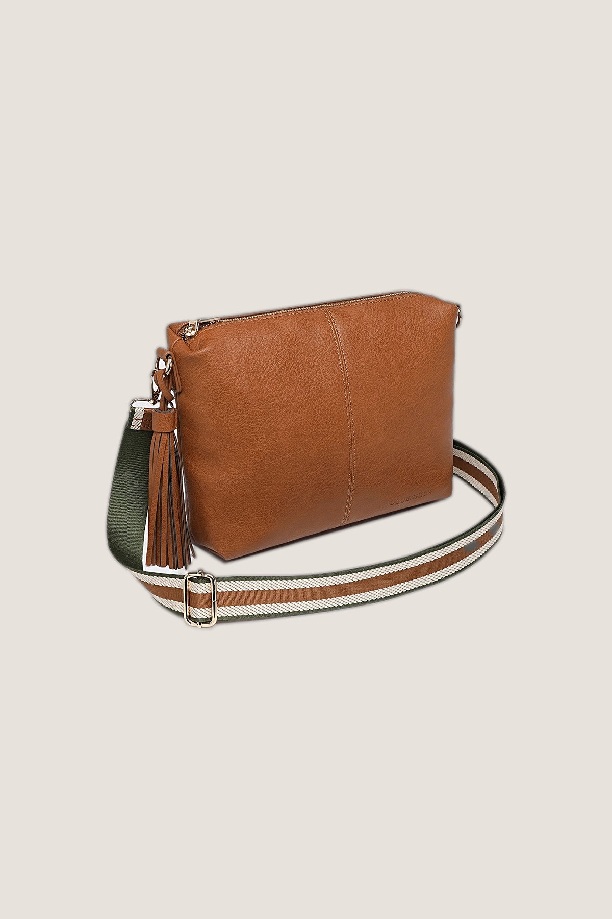 Three-quarter view of the Daisy Stripe Tan Crossbody Bag showing its depth, tassel and striped strap.