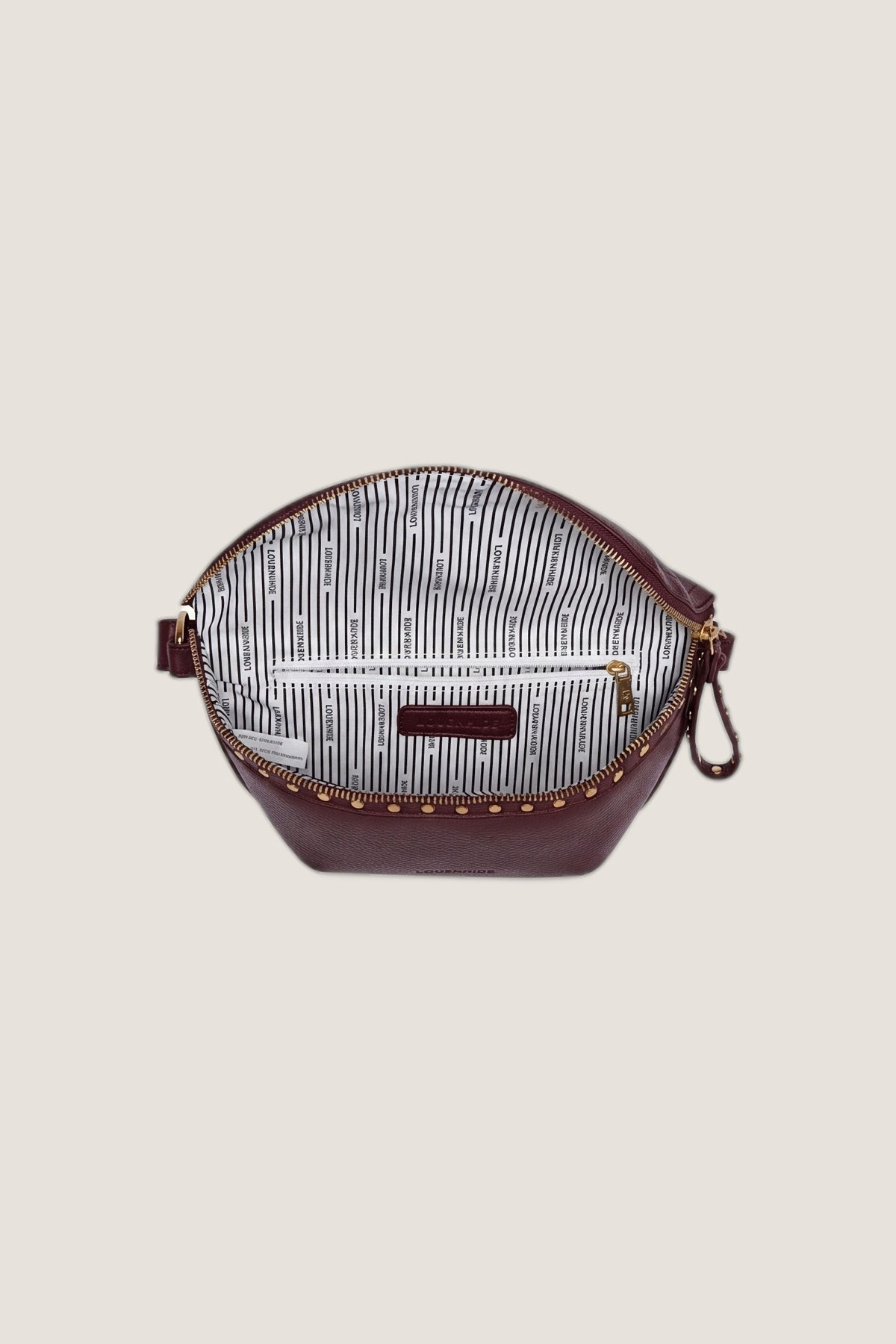 The Cassidy Burgundy Belt Bag unzipped from above, showing the striped lining and inside zip pocket.