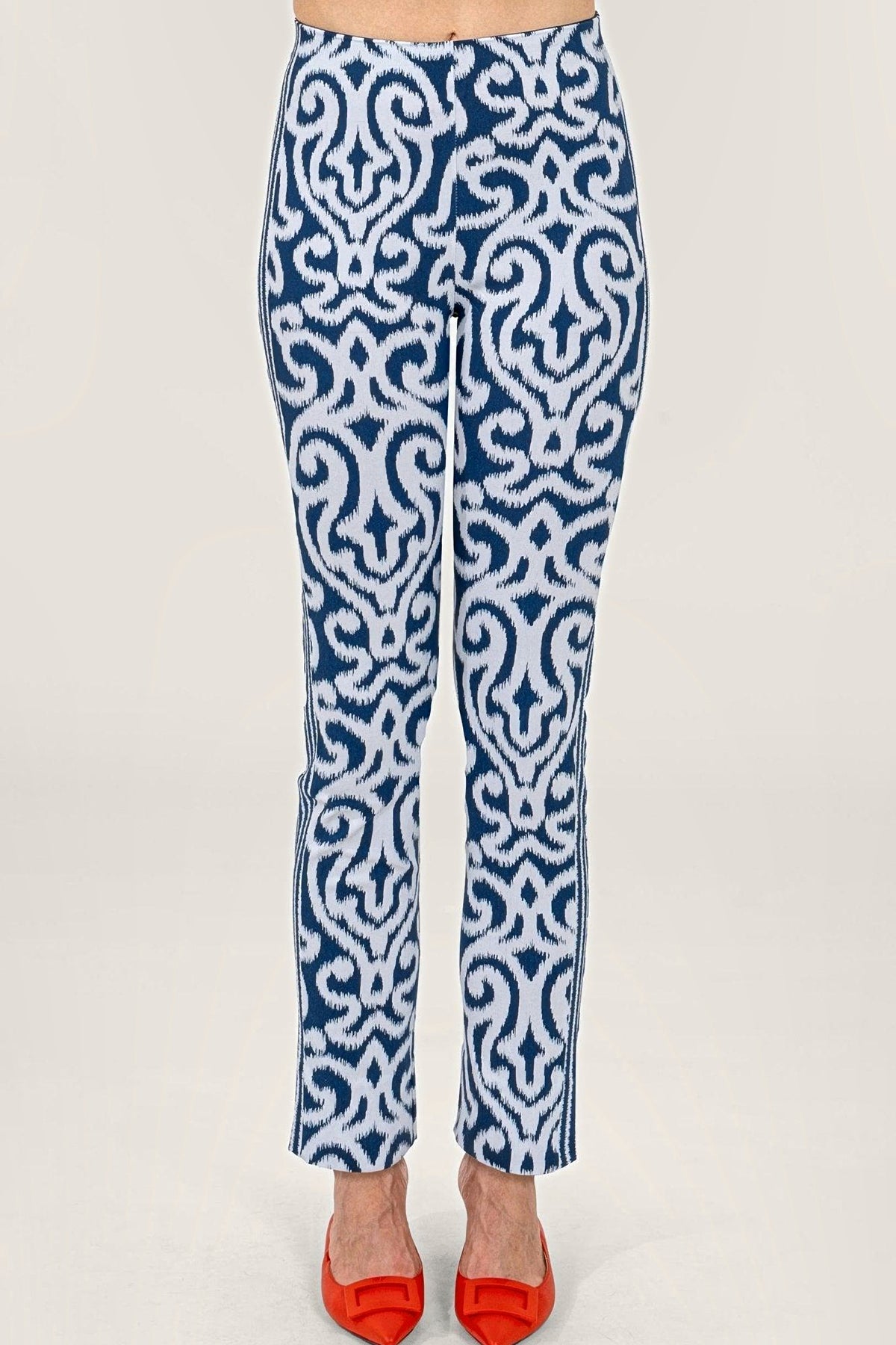 Front view of navy and white arabesque print pull-on pants worn with red flats.
