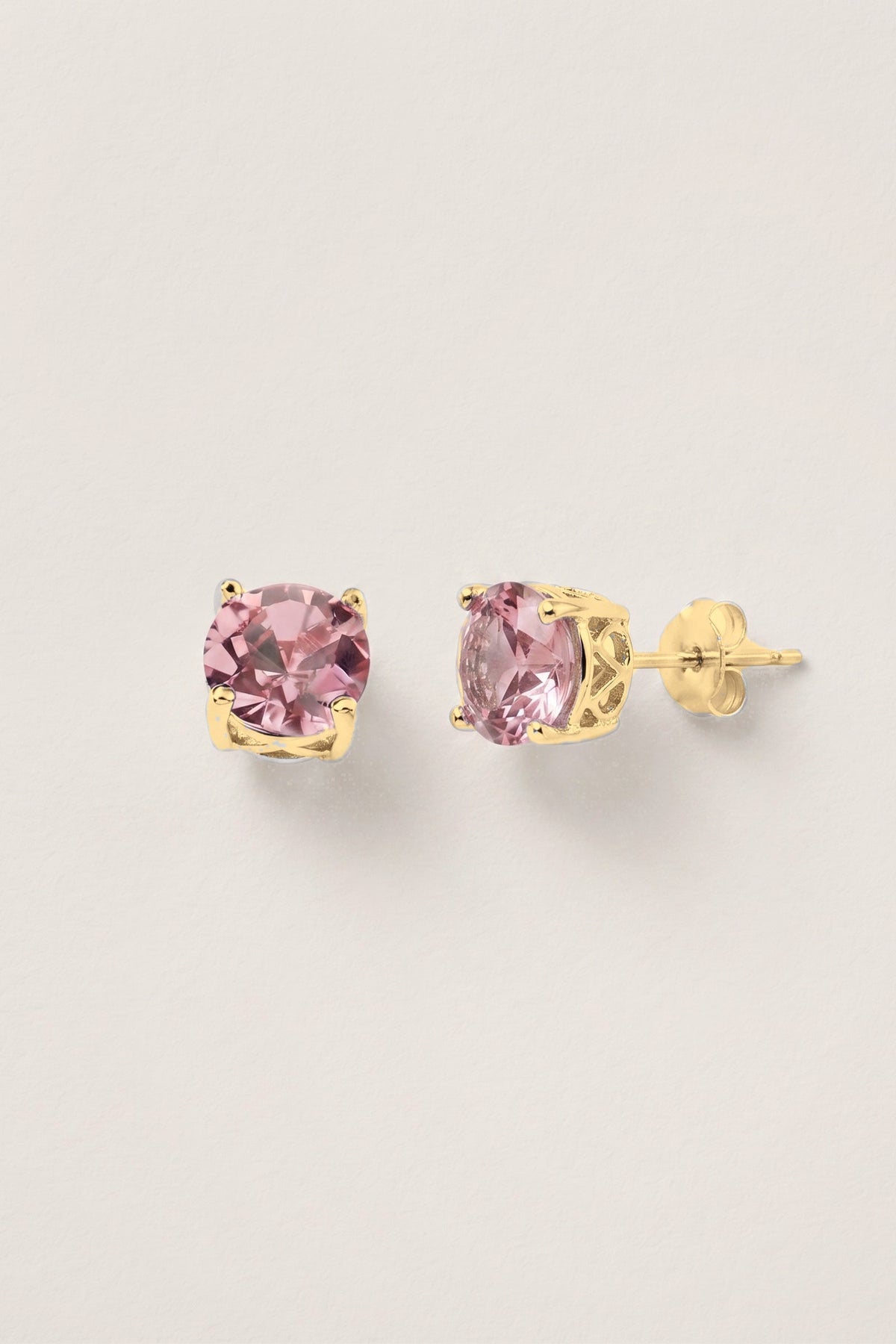 Baby Pink Sparkle Stud Earrings: a pair of round pink crystal studs in a gold-tone prong setting, one turned to show the post.