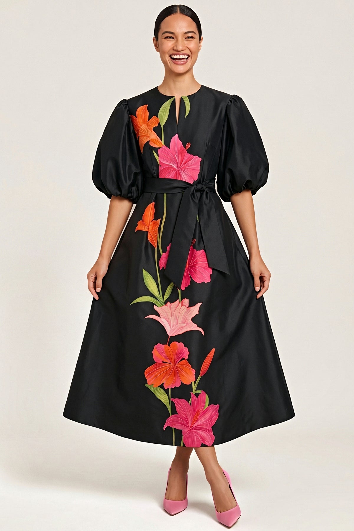 Front view of the black taffeta Botanical Noir midi dress with balloon puff sleeves, tie belt and placed floral print.