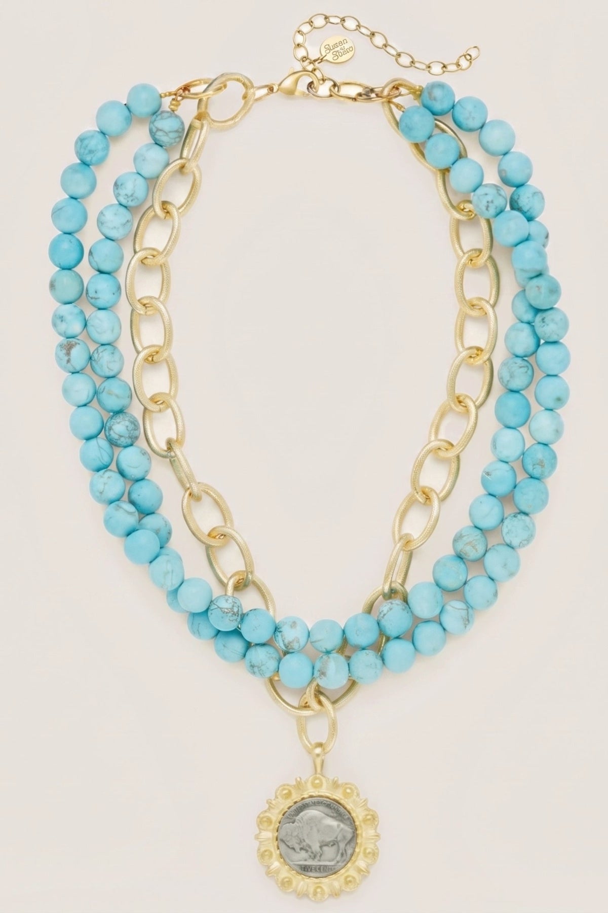 Gold and Buffalo Nickel on 3 Row Matte Turquoise Necklace, laid flat: three strands of turquoise beads and gold chain with a Buffalo nickel pendant.