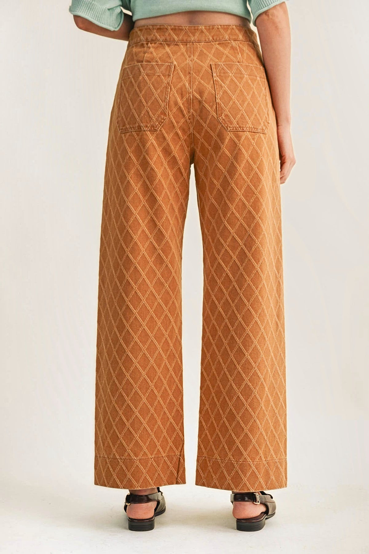 Back view of the diamond quilted wide-leg pants, showing the back patch pockets.