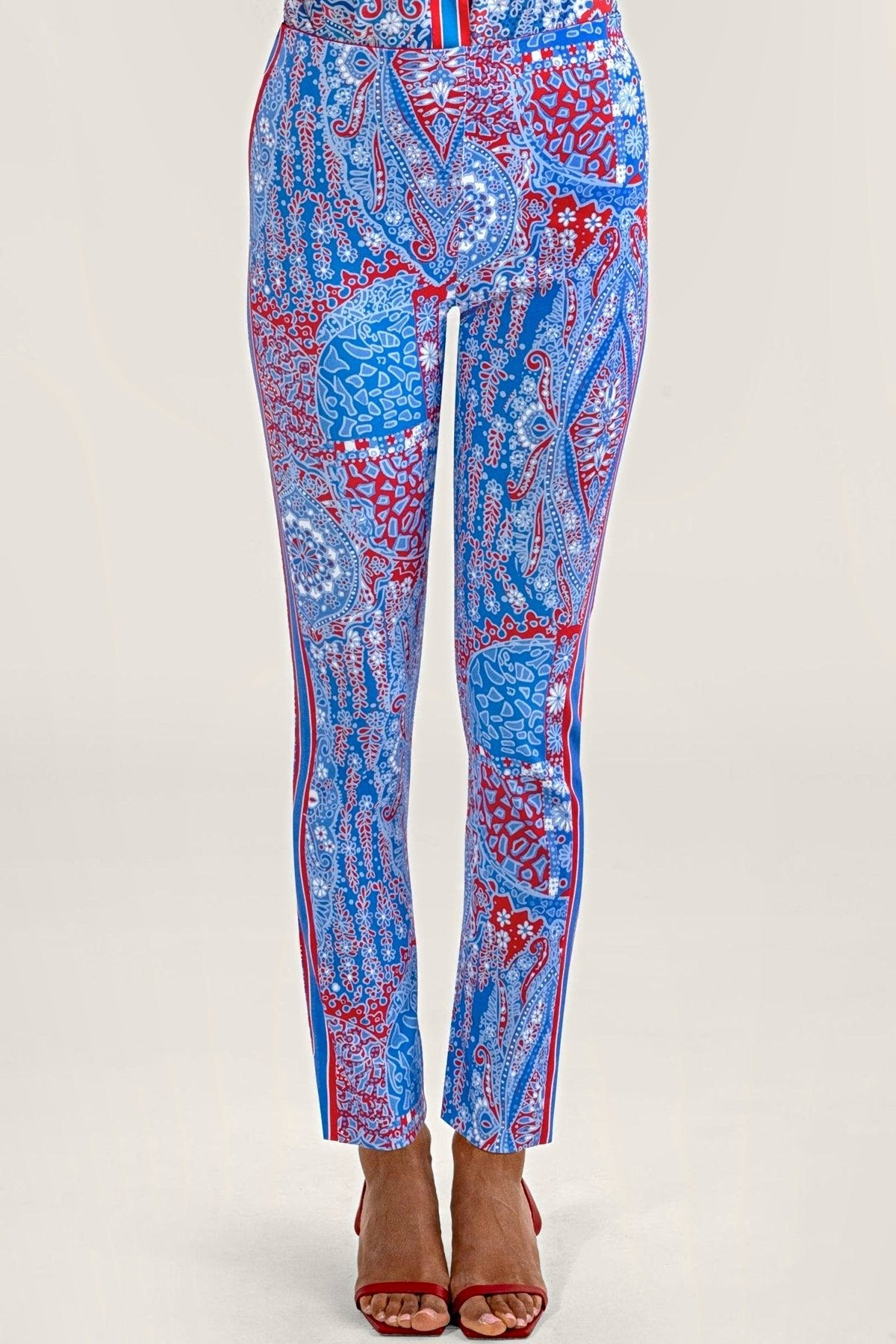 Front view of blue and red paisley print pull-on pants worn with red sandals.