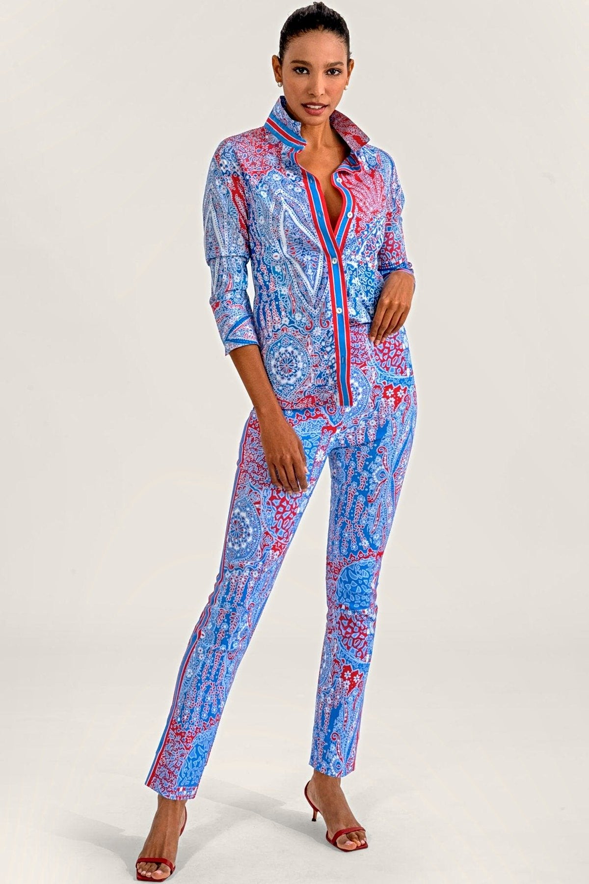 A woman in a matching blue and red paisley print shirt and pull-on pants.