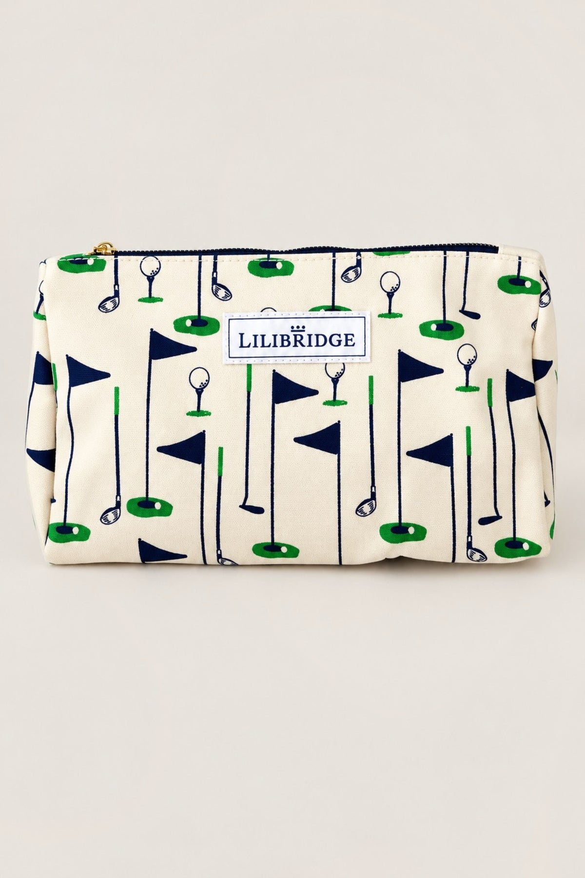 A rectangular zip pouch with an off-white background and a golf flag pattern in navy blue and green. A white label on the front reads 'LILIBRIDGE'.