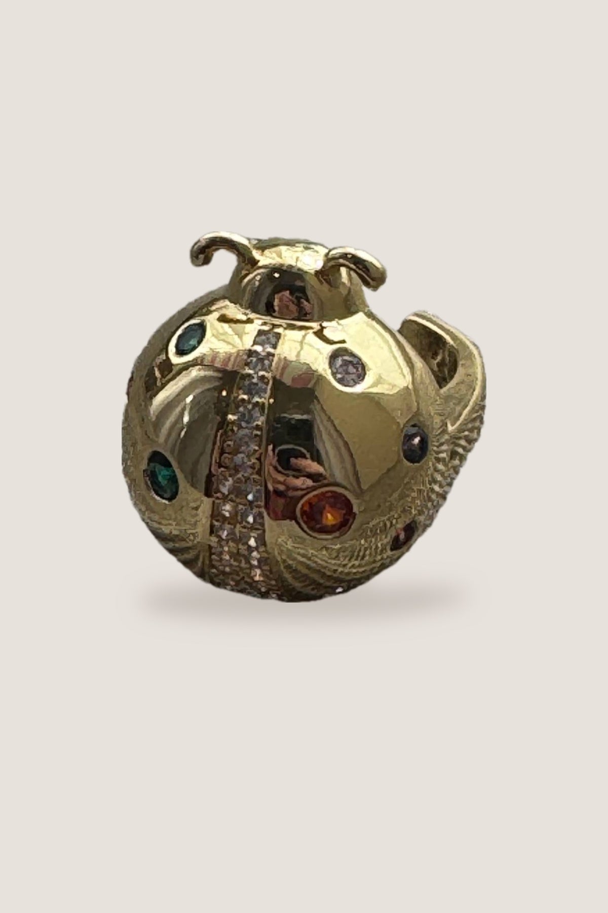 The gold Lady Bug CZ Ring: a domed gold ladybug with green, orange, purple and clear stones and a pave crystal stripe down its back.