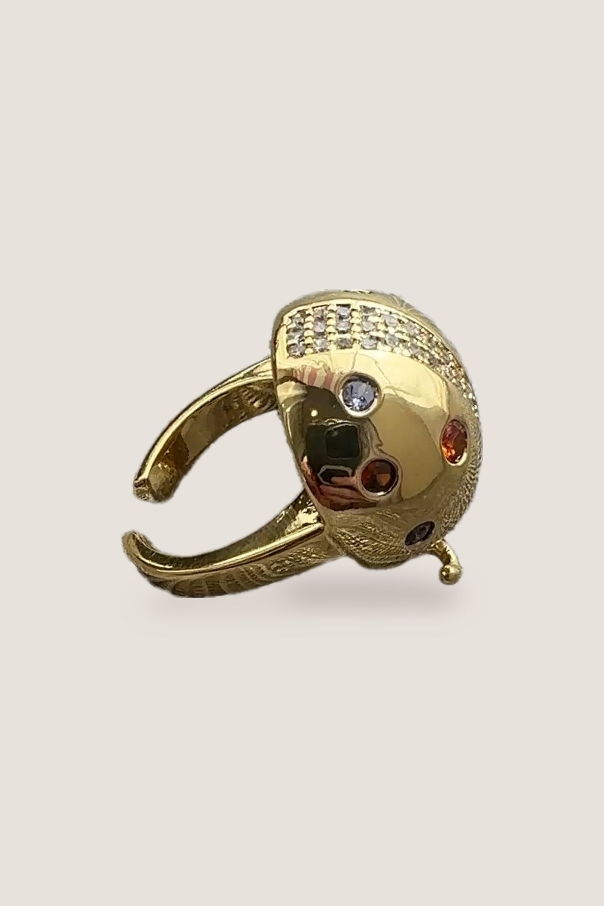 The Lady Bug CZ Ring from the side, showing its open, adjustable gold band and the pave crystal stripe.