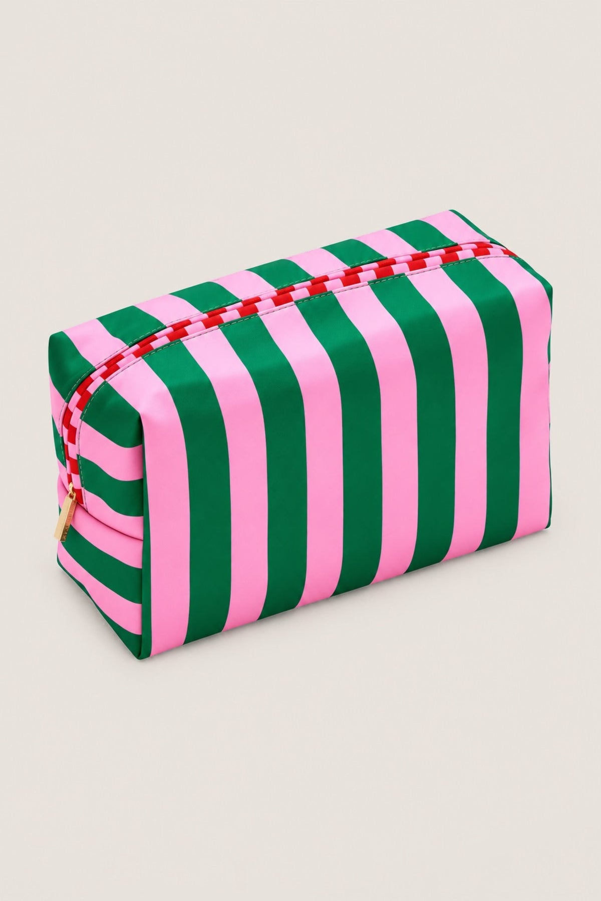 A rectangular zippered cosmetic pouch with bold vertical pink and green stripes, featuring a red-and-white patterned zipper and a small gold zipper pull, shown on a plain light background.