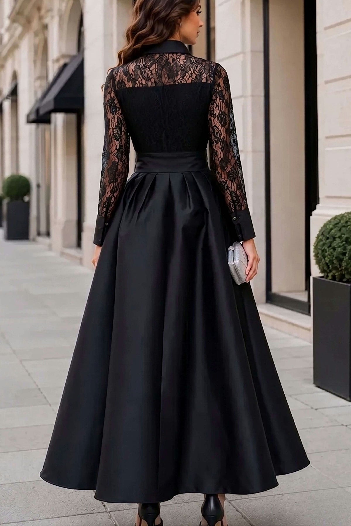 woman in black lace dress on a street