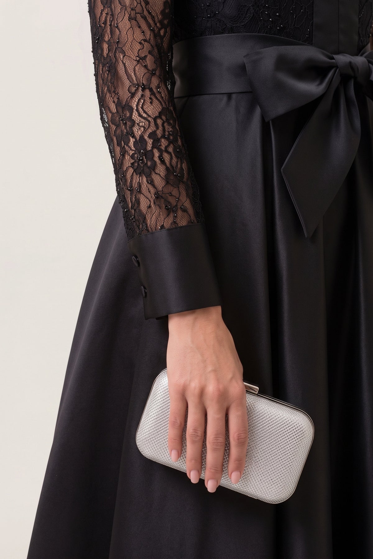 Close-up of the beaded lace sleeve and satin cuff of the Midnight Romance Beaded Lace Maxi Dress, with the satin bow at the waist