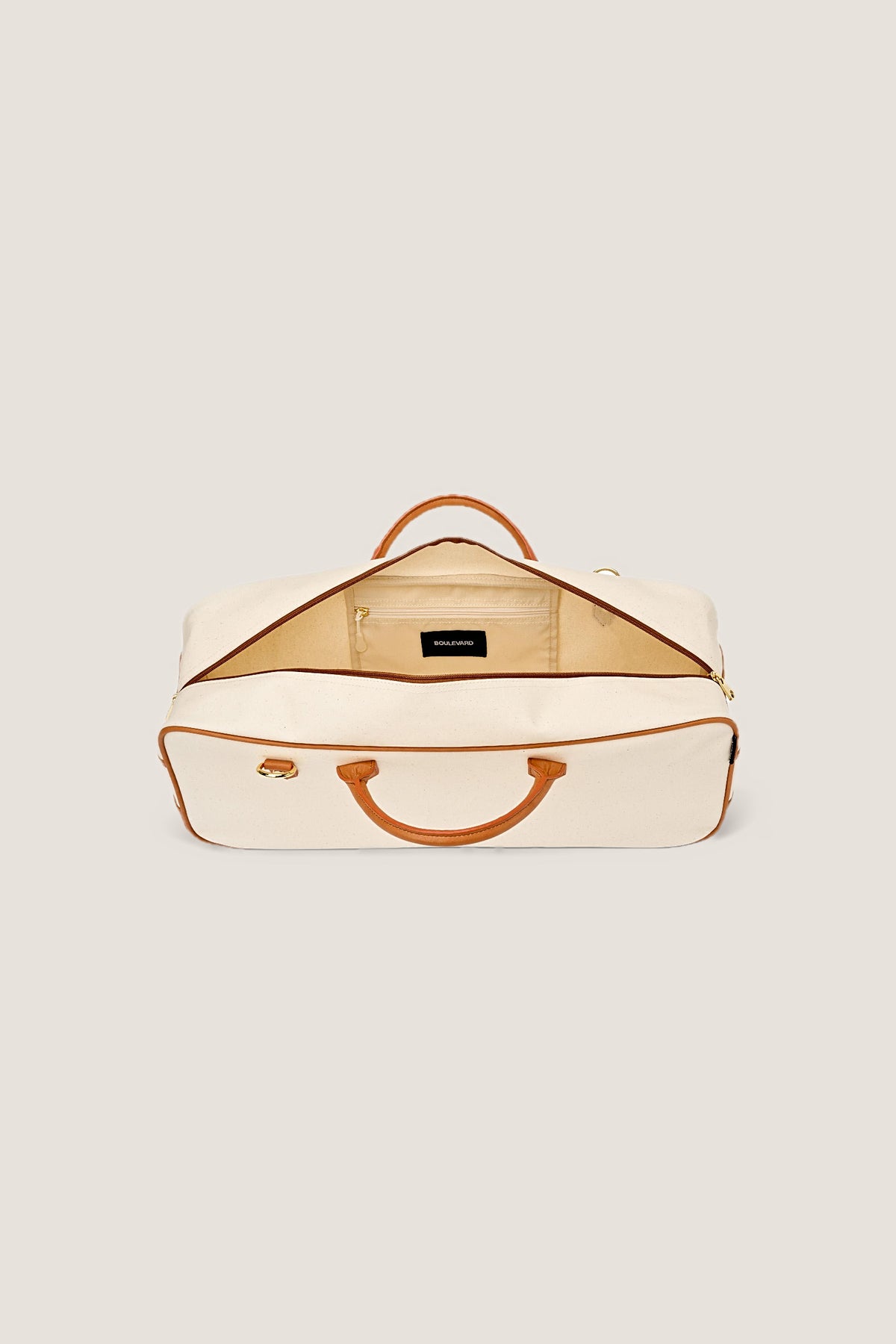 Inside the Mint Margo mahjong tote, unzipped, showing the lining and zip pocket.