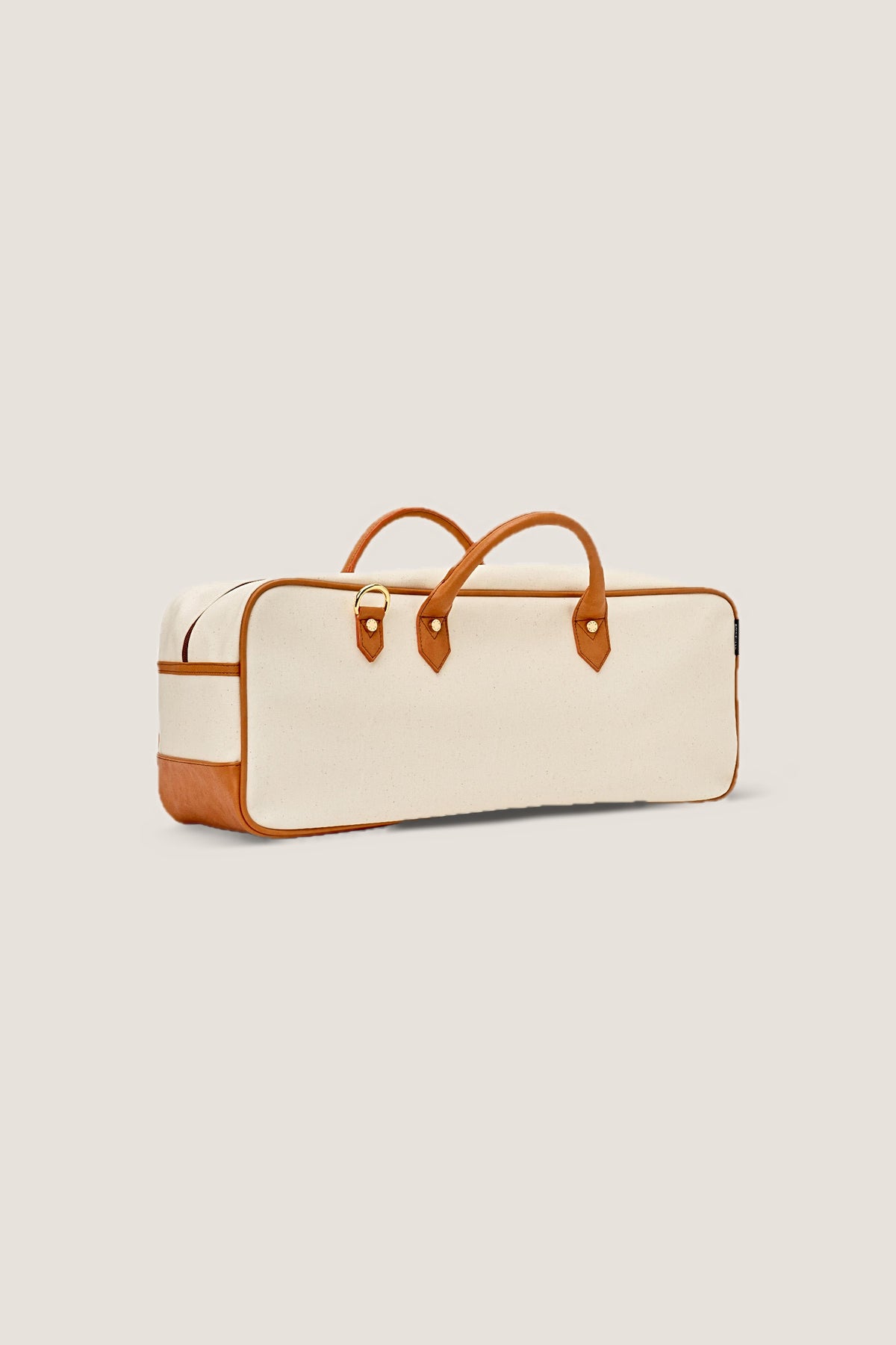 The Mint Margo mahjong tote at a three-quarter angle, showing its depth and cognac base.
