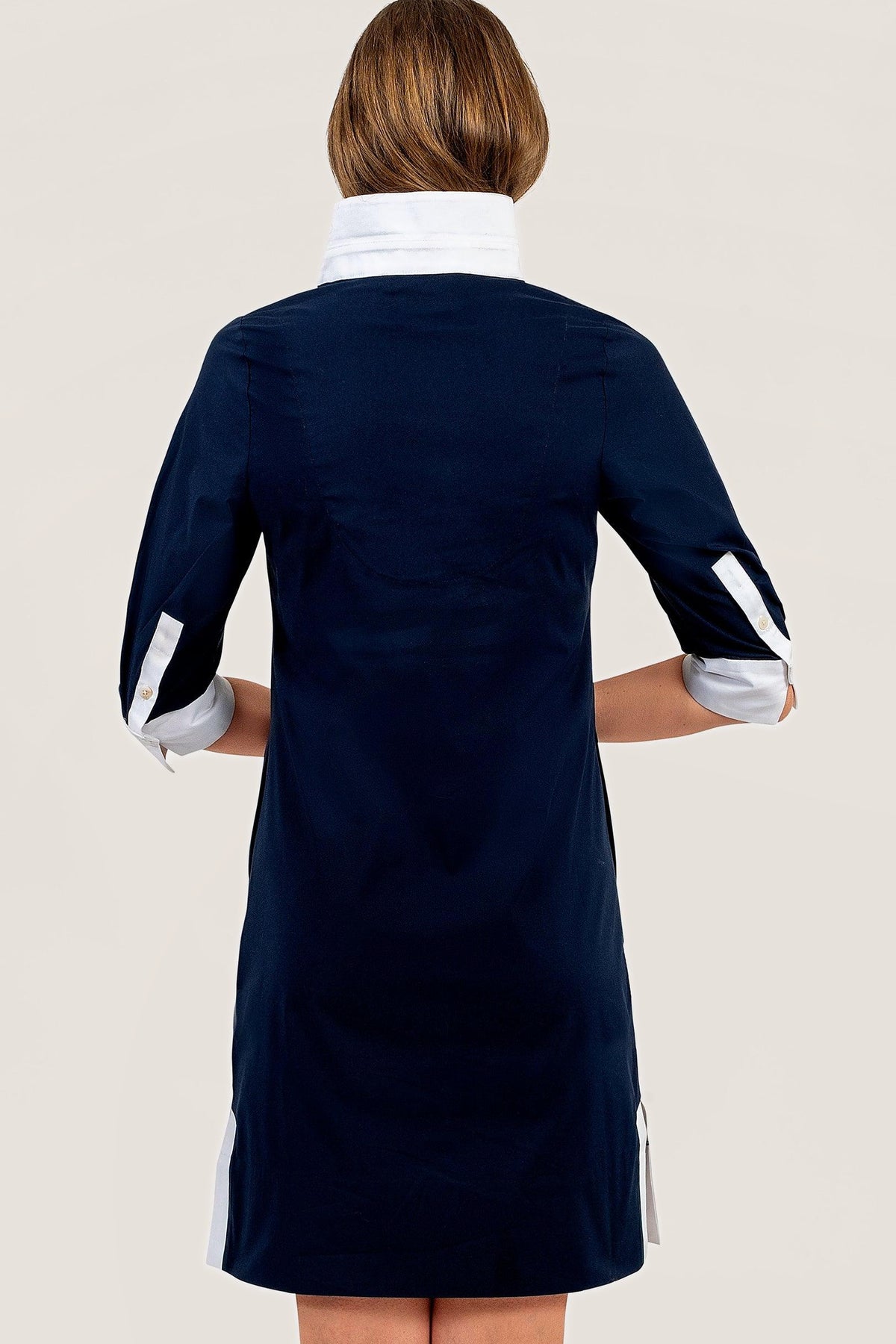 Back view of the navy cotton tunic dress with white cuffs.