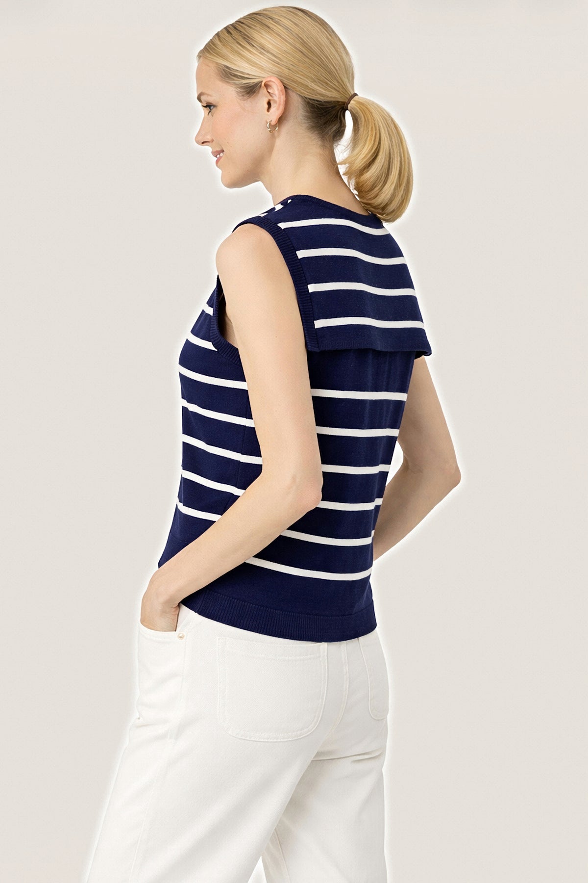 Side view of the navy striped sleeveless knit sailor sweater.