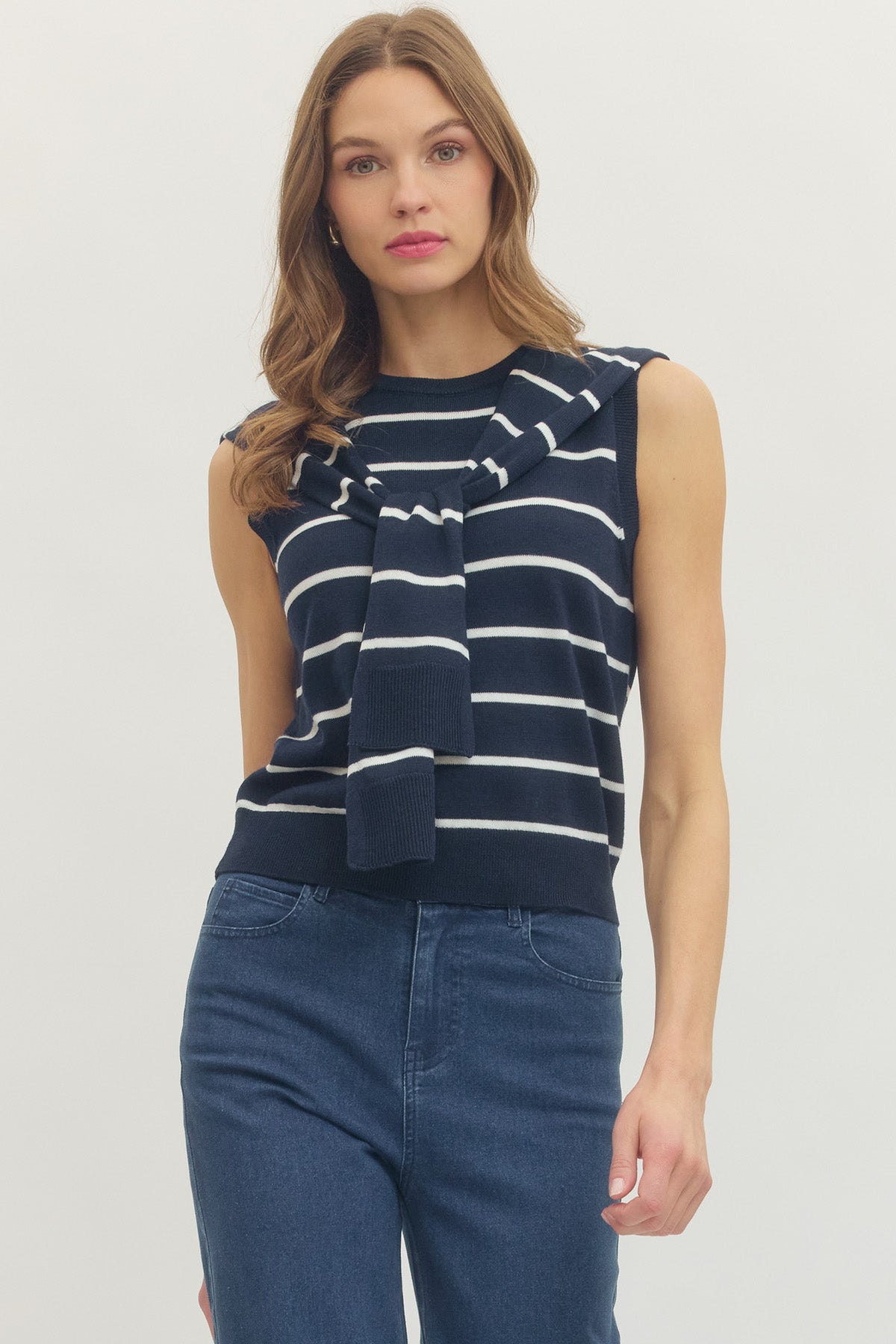 The navy striped sleeveless sailor sweater styled with jeans.