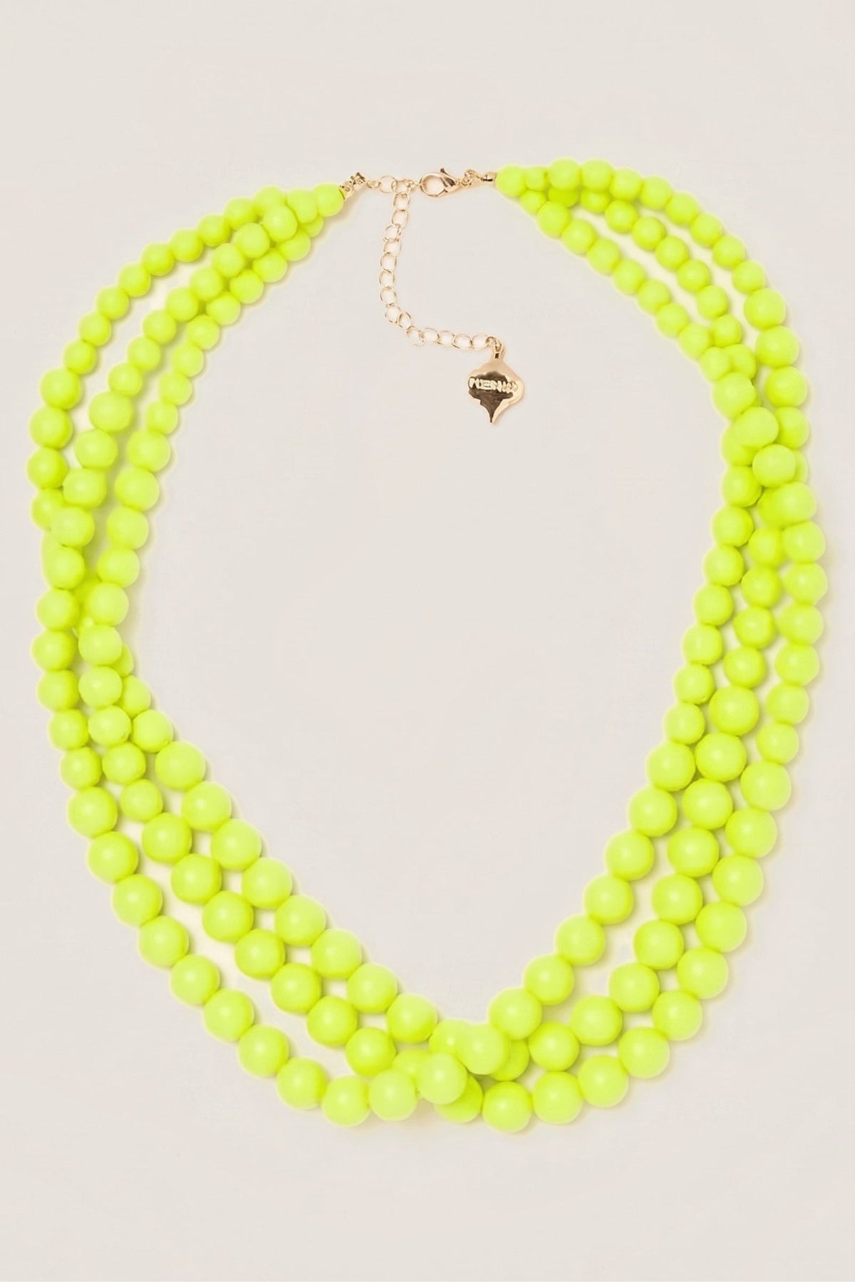 Neon Yellow Winnie Triple-Strand Beaded Necklace laid flat, showing the three bead strands and the gold extender chain.