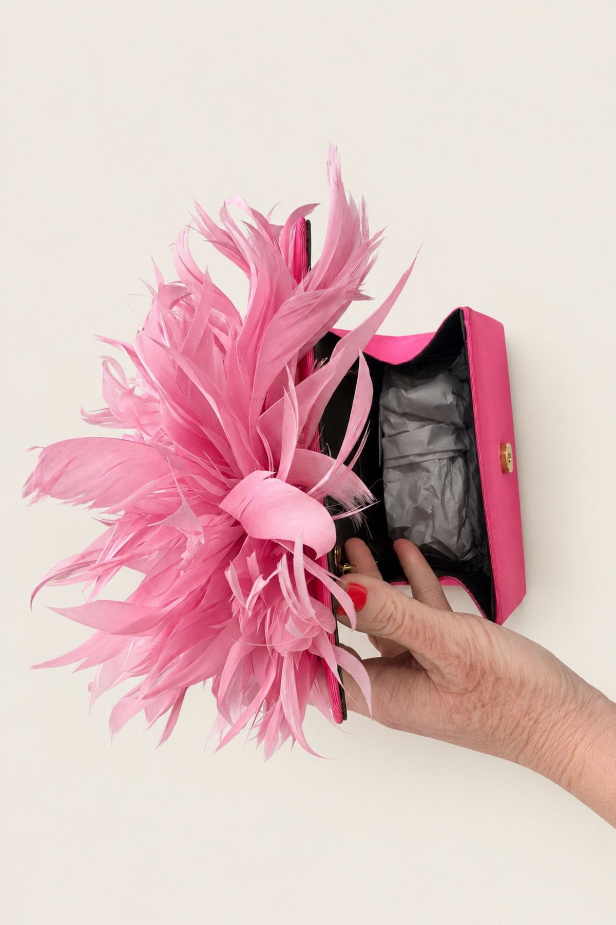 The inside view of the pink feather plume clutch showing the amount of space inside the clutch