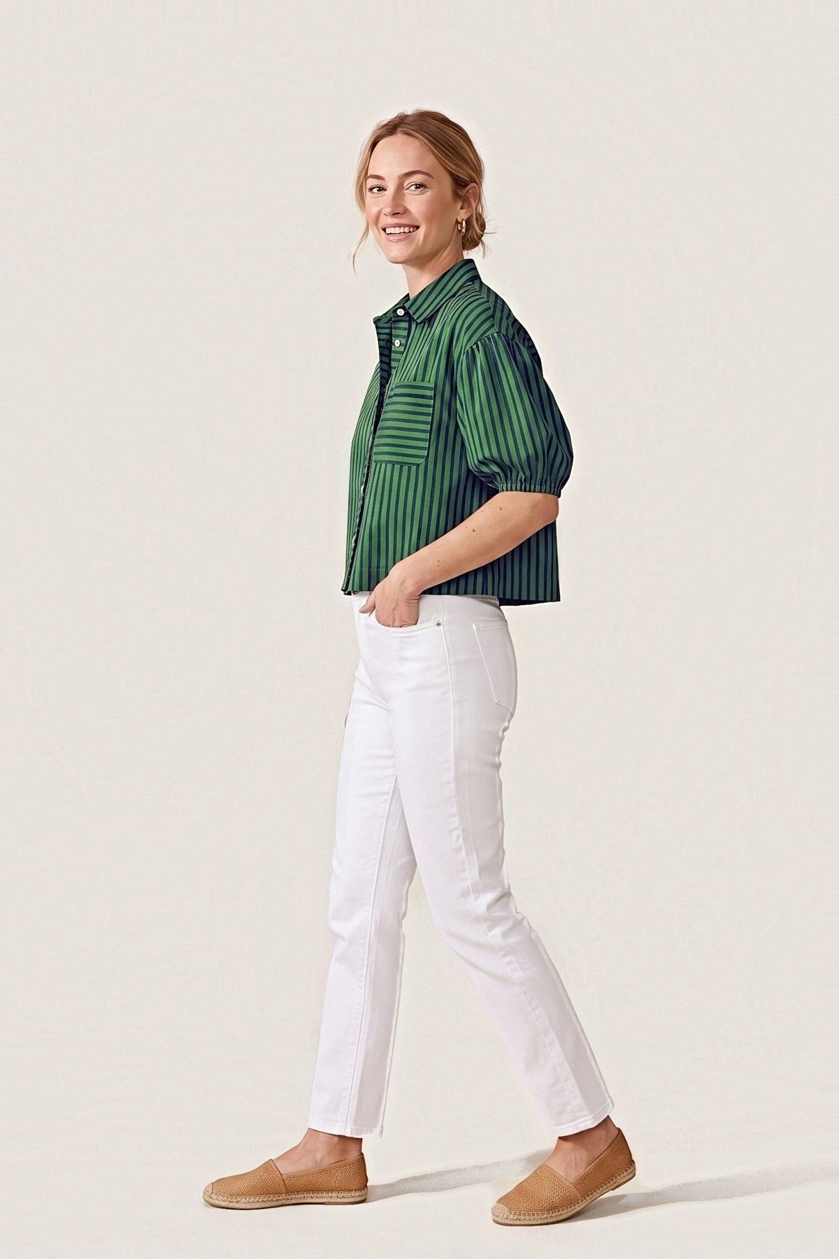 Side view of the Preppy navy and green stripe top in motion, showing the balloon sleeve and boxy cropped length.
