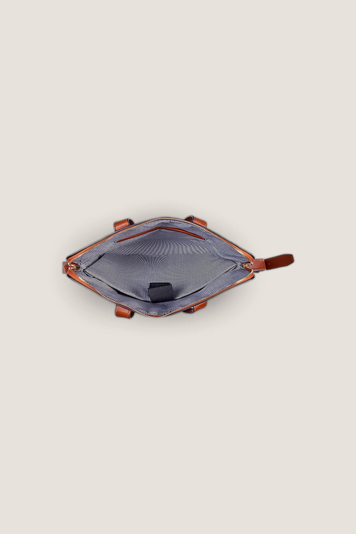 Inside the tan Rhodes Laptop Bag, opened from above, showing the striped lining and padded laptop sleeve.