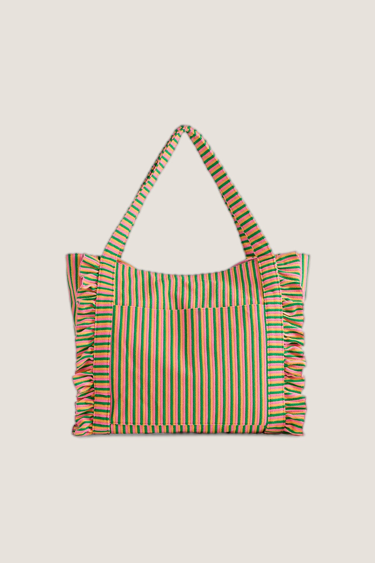 The Sirena Tote in pink, orange and green terry stripes with ruffled side edges, standing with its handles up.