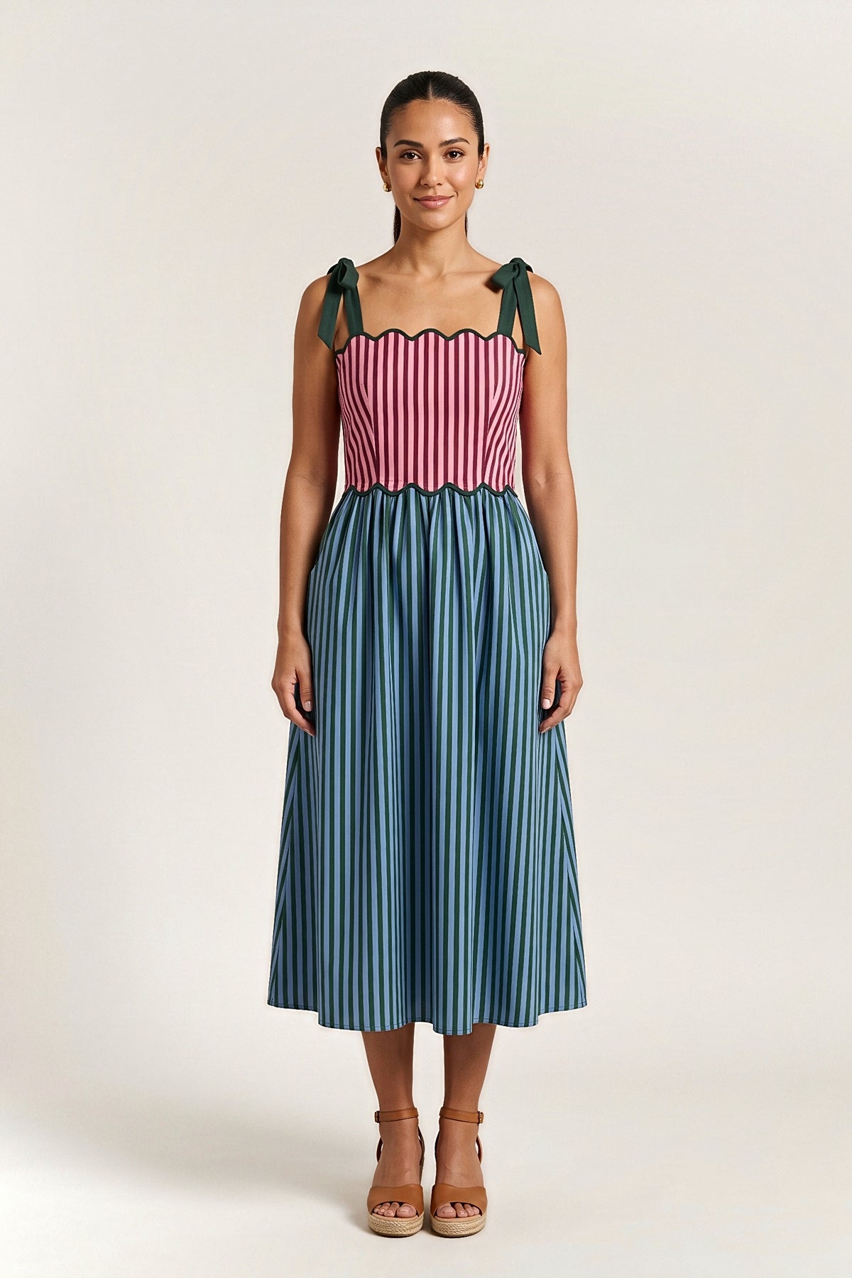 Front view of the Bordeaux Garden midi dress with a scalloped striped bodice, green tie straps and a striped full skirt.
