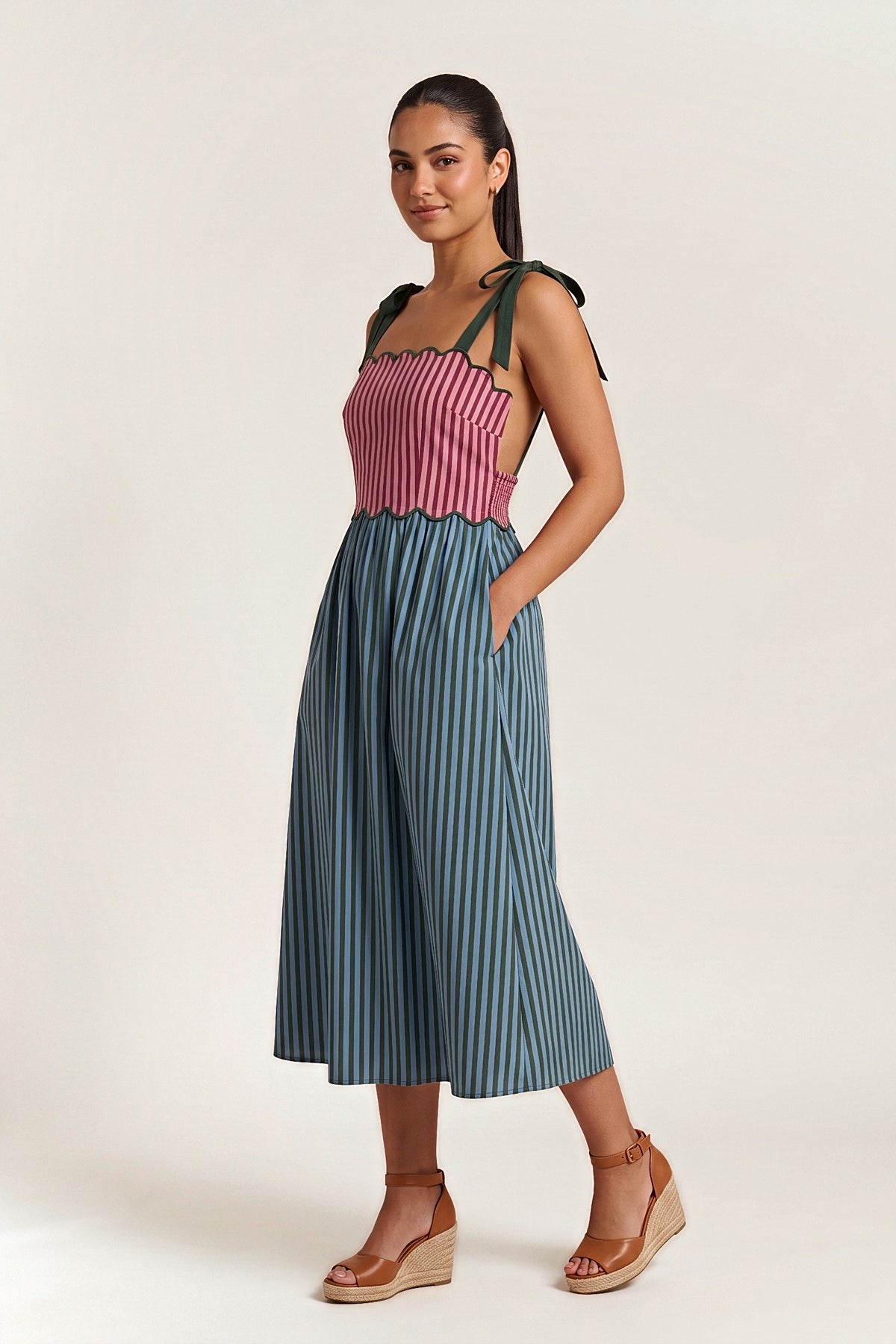 Three-quarter view of the Bordeaux Garden midi dress with one hand in the side pocket.