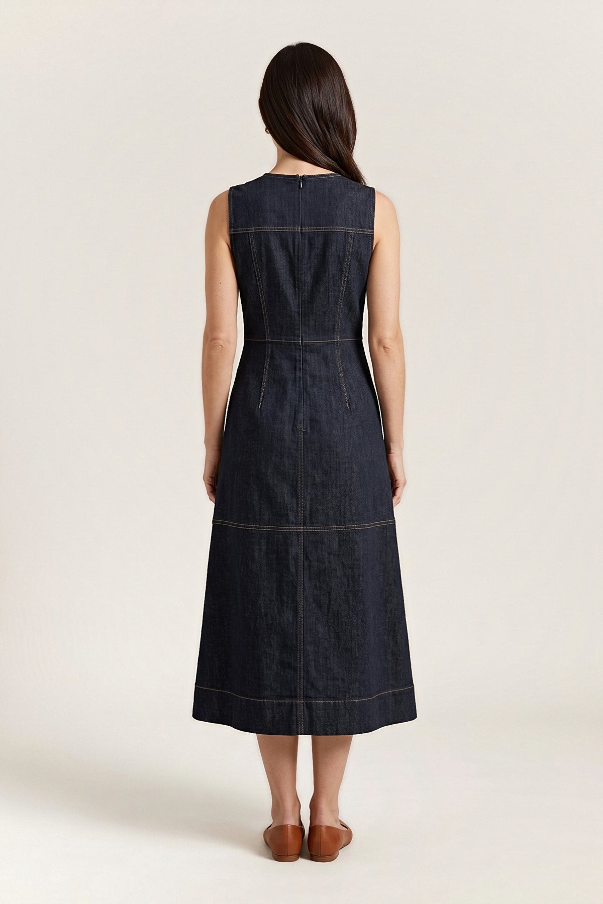 Back view of the dark denim midi dress with a centre-back zip and gold topstitched seams.