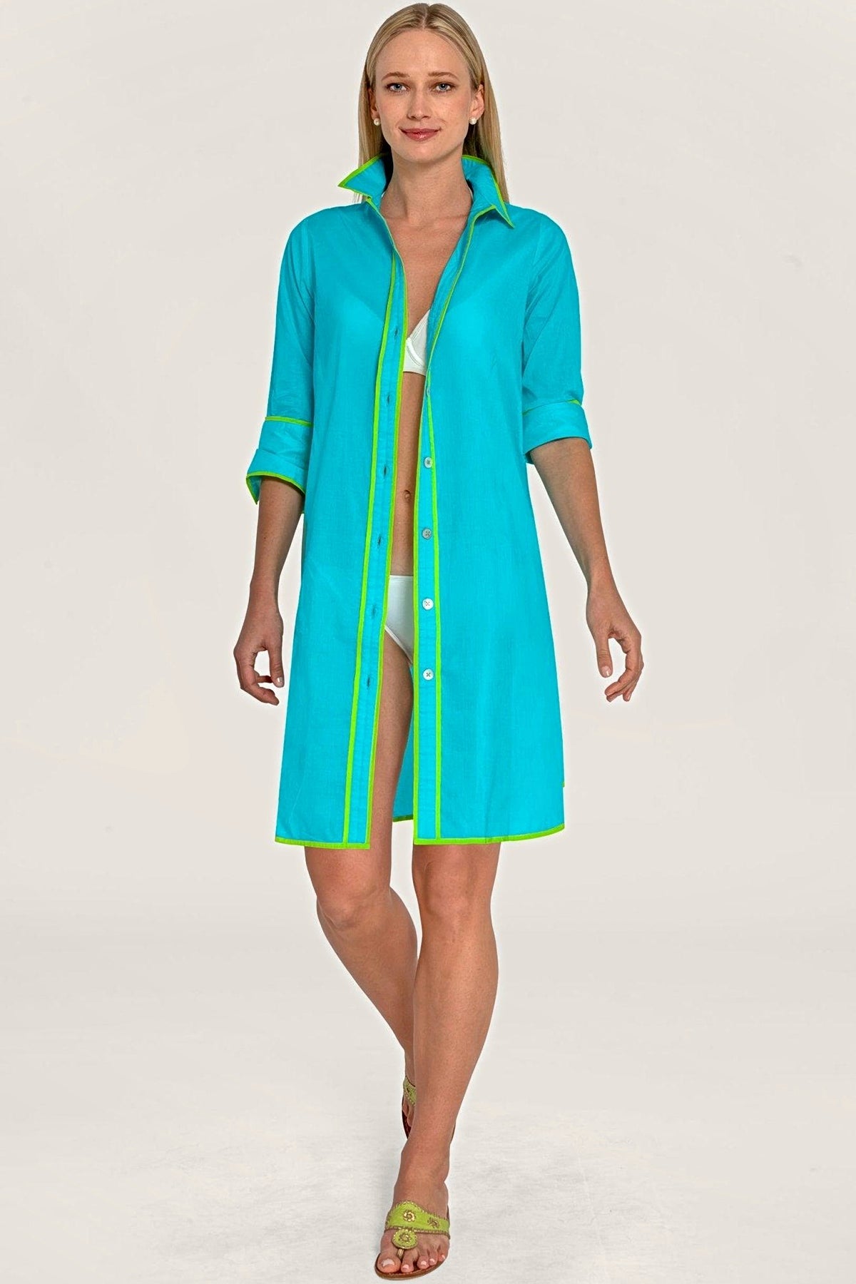 The turquoise shirt tails dress worn open as a cover-up.