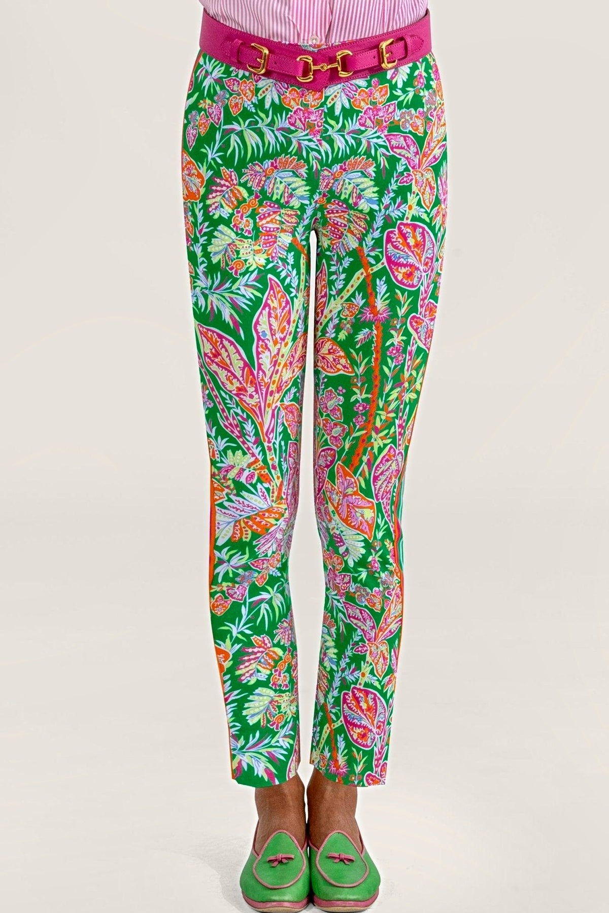 Front view of kelly green vine print pull-on pants with a pink belt and green loafers.