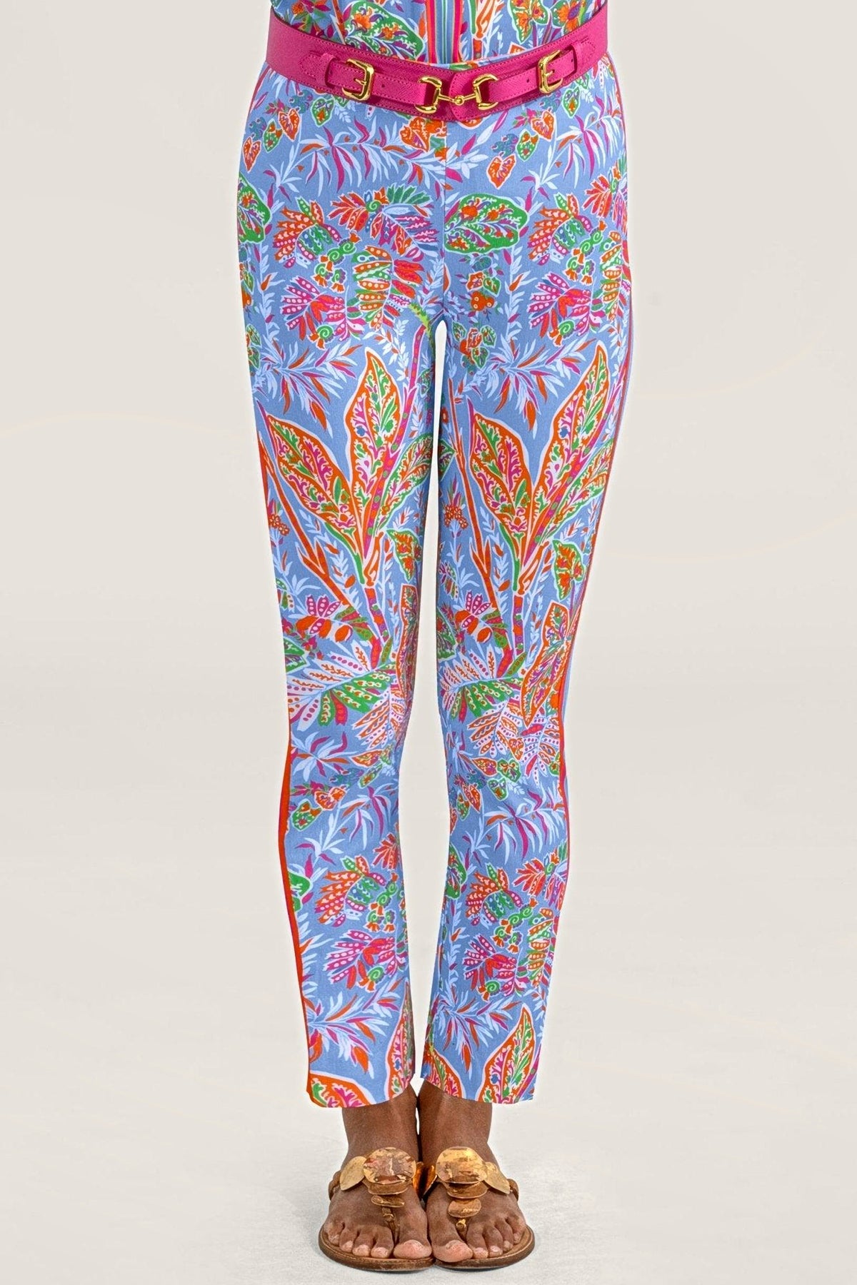 Front view of periwinkle vine print pull-on pants with a pink belt and gold sandals.