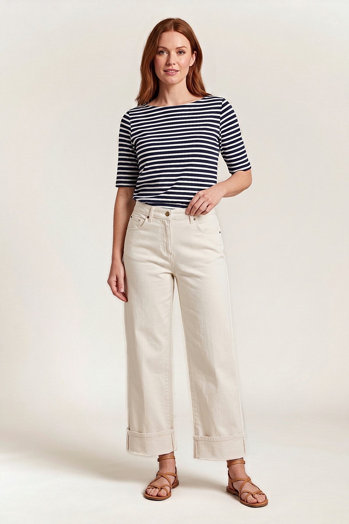 Front view of the off-white Weekend Edit wide-leg jeans with deep turned-up cuffs, worn with a navy striped top.