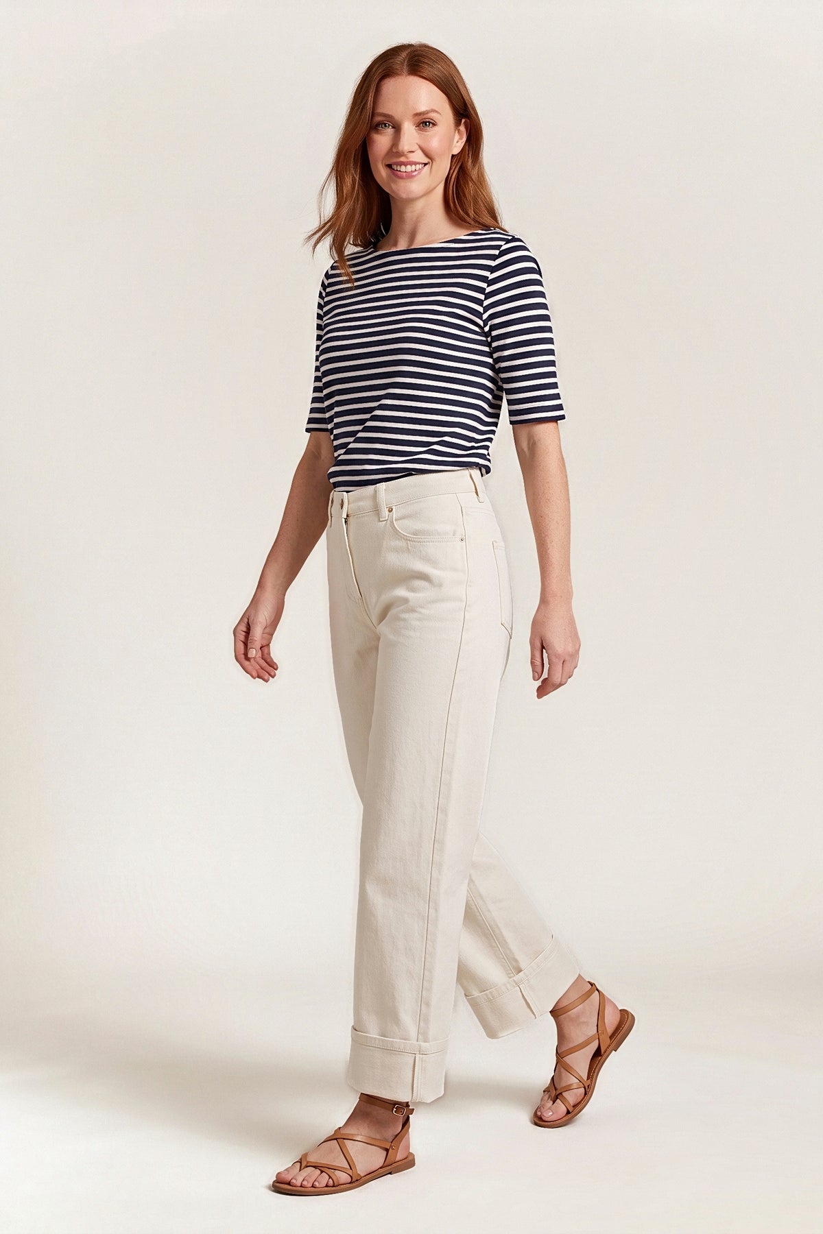 Three-quarter view of the off-white wide-leg jeans in motion, showing the relaxed leg and cuffs.
