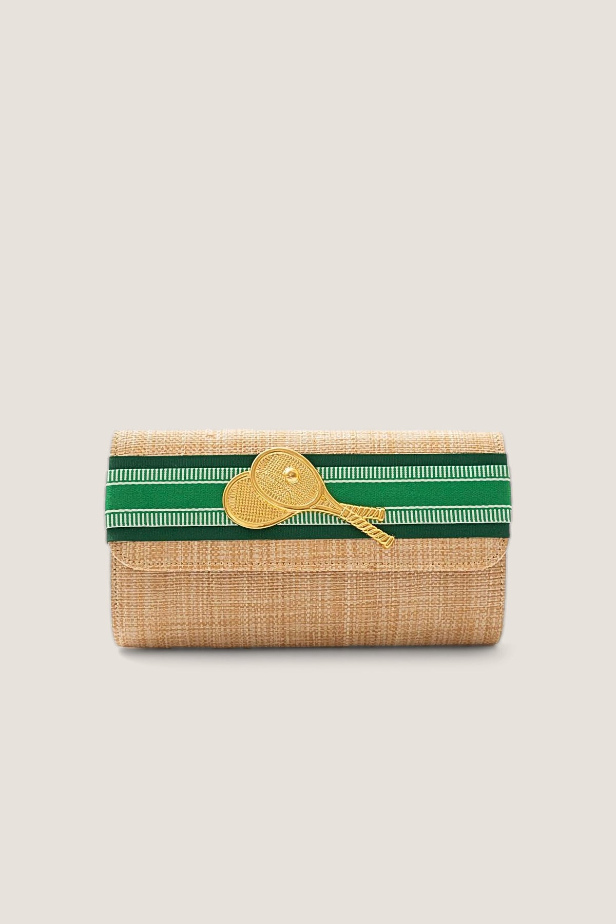 The Lisi Lerch Avery Straw Clutch with a green palm and hunter striped band and a gold double tennis racket charm, shown front on.