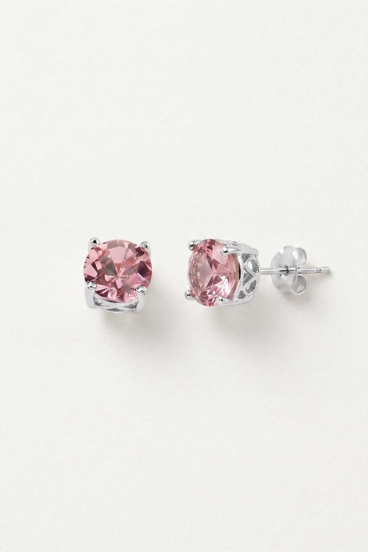 Baby Pink Sparkle Stud Earrings on a cream background