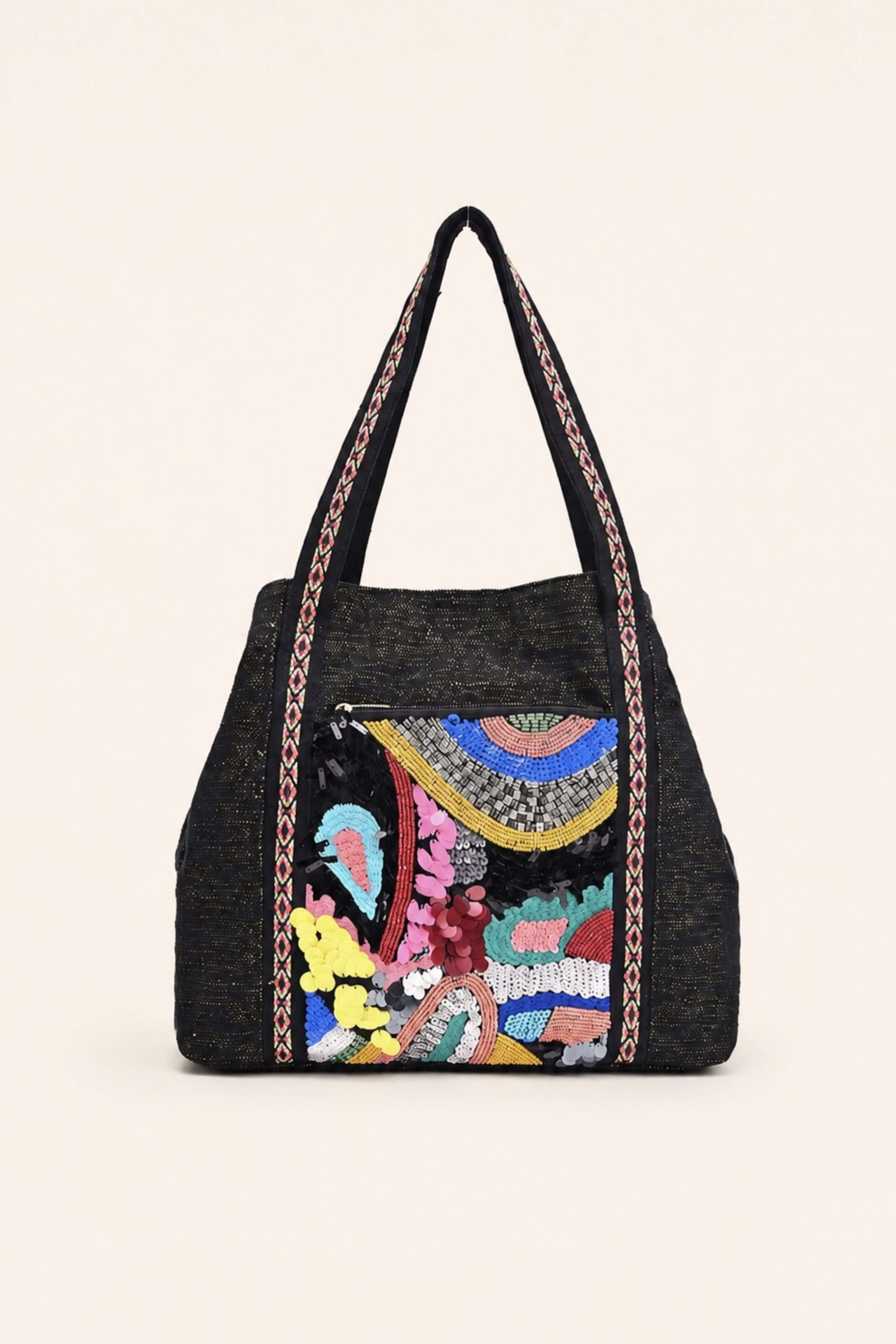 A black woven tote bag featuring a colorful, hand-embroidered front panel with a circular mandala design and floral motifs, complete with dual shoulder straps.