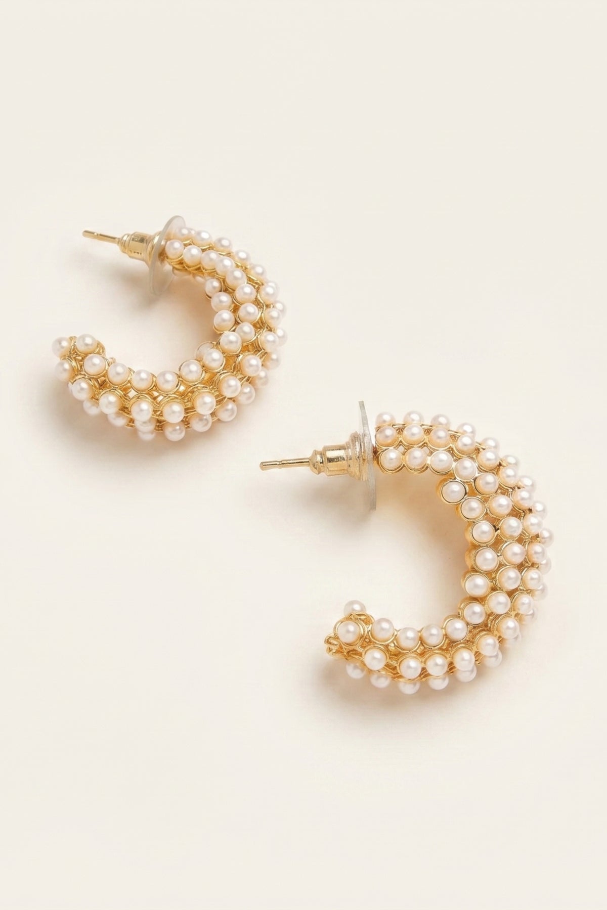 Blakely Pearl Hoop Earrings on a cream background