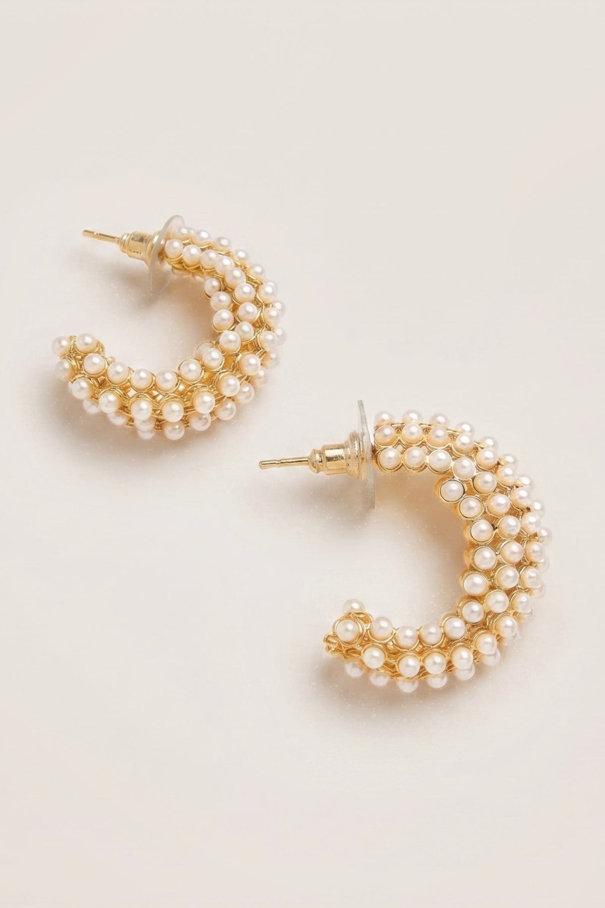Blakely Pearl Hoop Earrings on a cream background