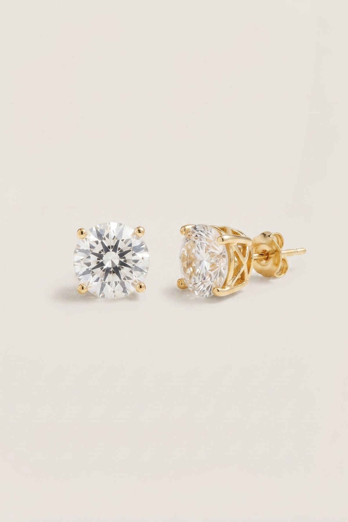 Classic Clear Sparkle Studs | Gold Tone Setting on a cream background