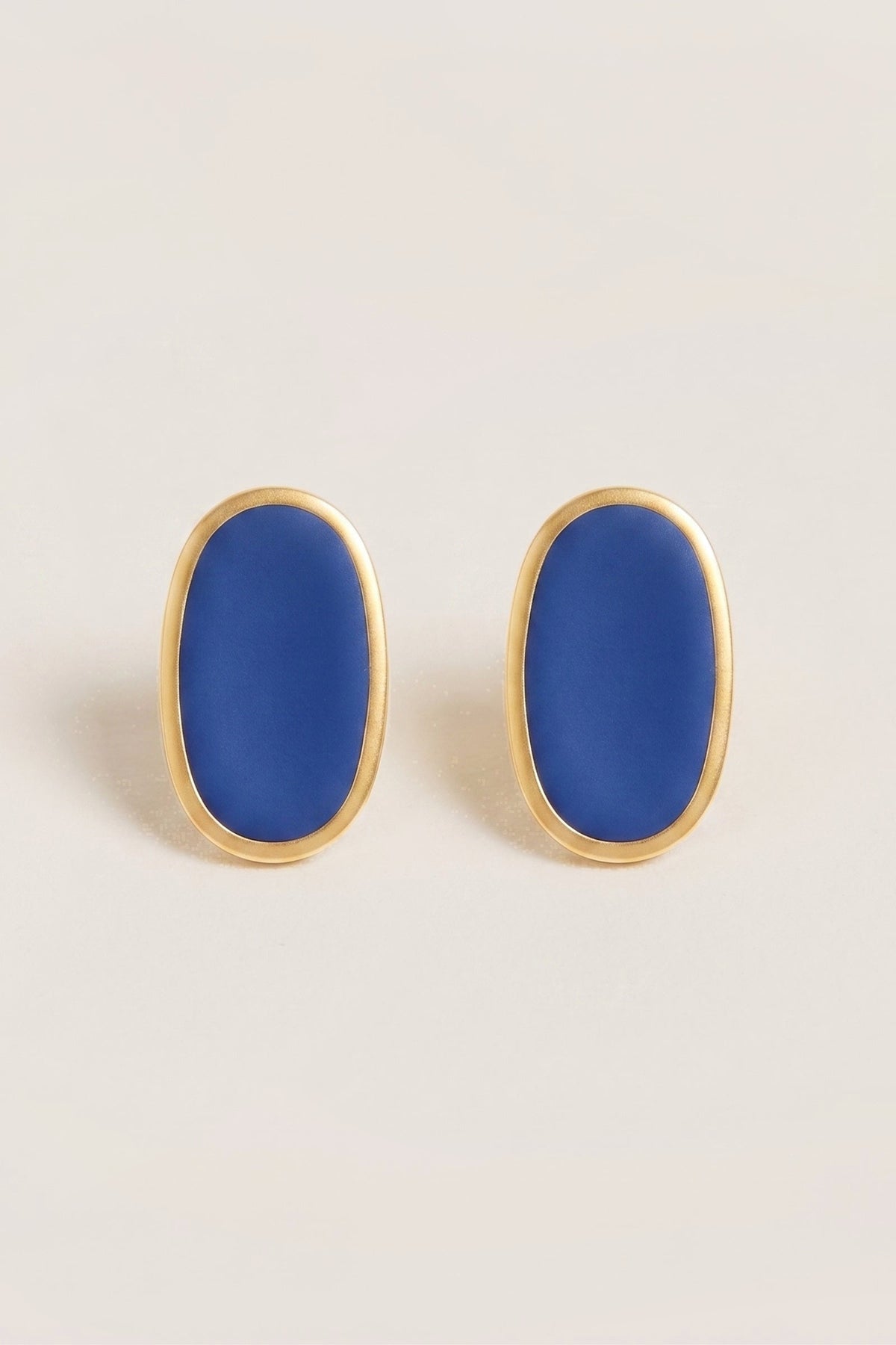 Navy Alexis Oval Enamel Post Earrings on a cream background