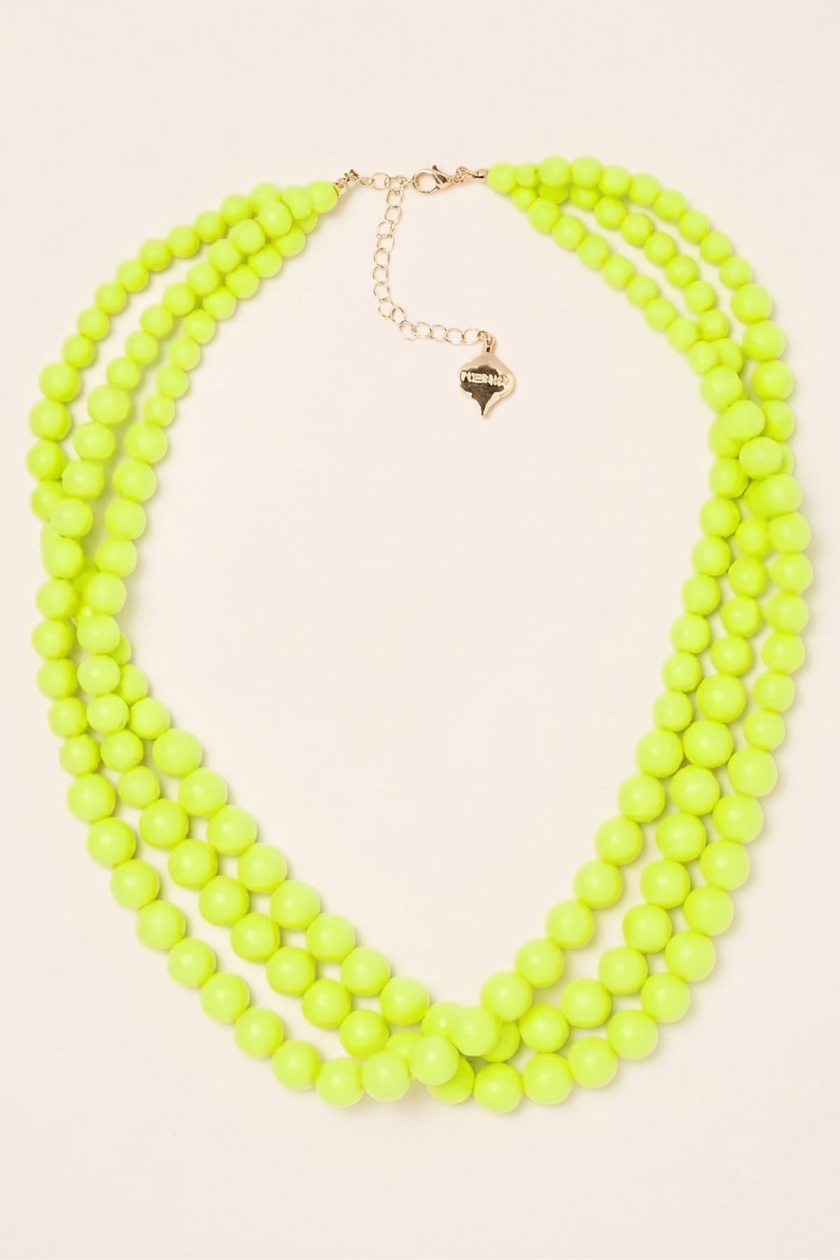 Neon Yellow Winnie Triple-Strand Beaded Necklace on a cream background