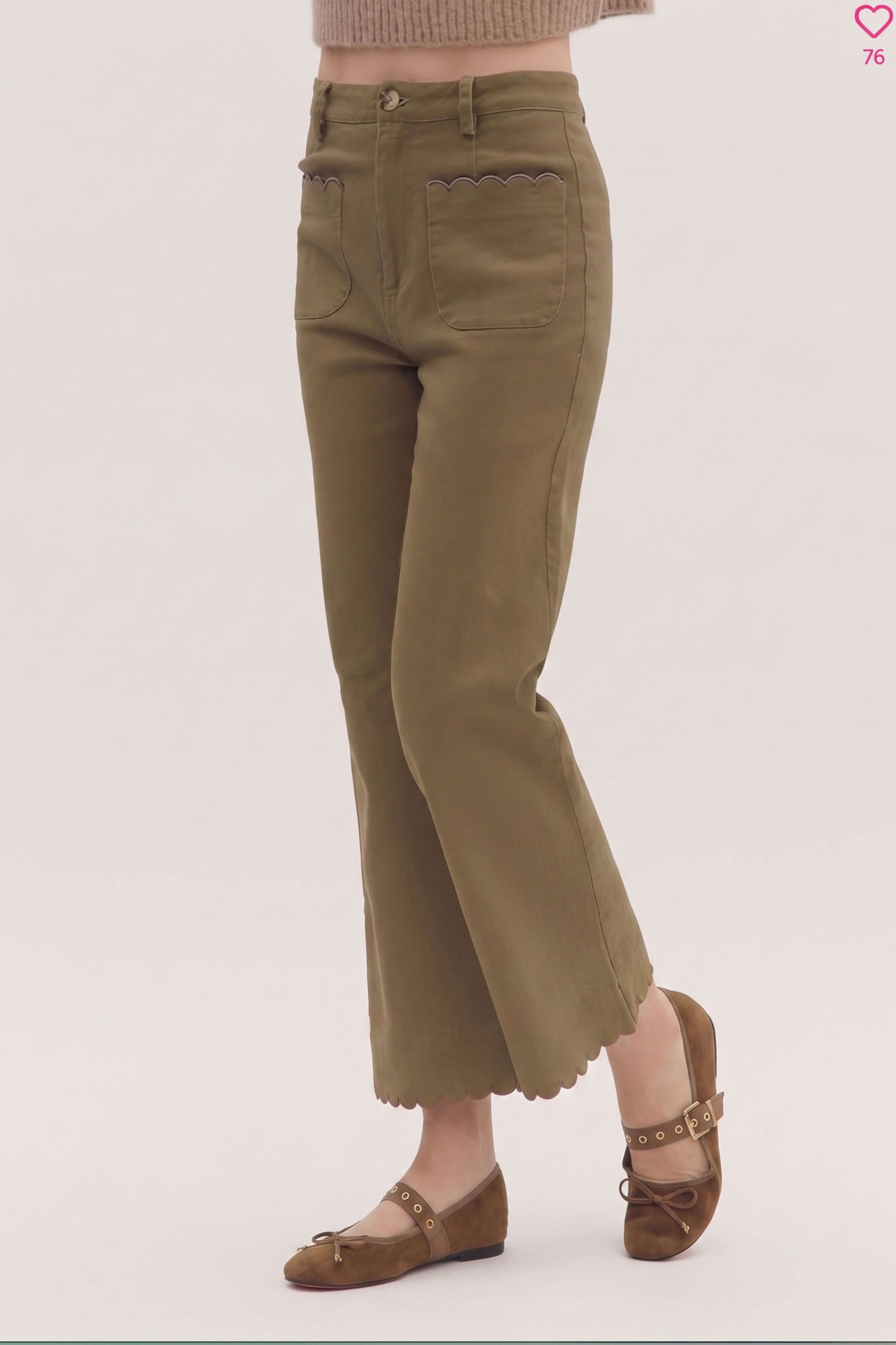 A person wearing olive green cropped flare pants with scalloped hems, paired with brown flat shoes, shown from the waist down against a plain light background.