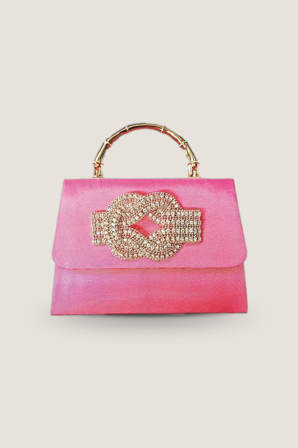 The Lisi Lerch Pink Faille Lulu with a gold bamboo handle and a rhinestone knot on the flap, shown front on.