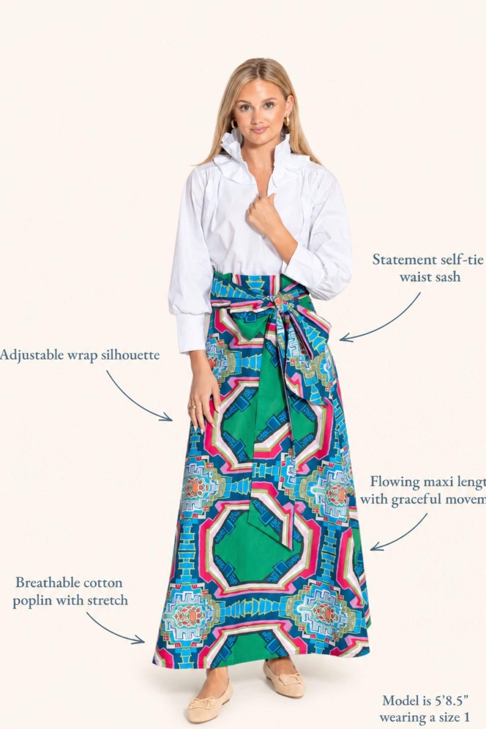 A woman modeling a long wrap-style maxi skirt with a colorful geometric print, paired with a white blouse, on a light beige background with text callouts describing the skirt features.