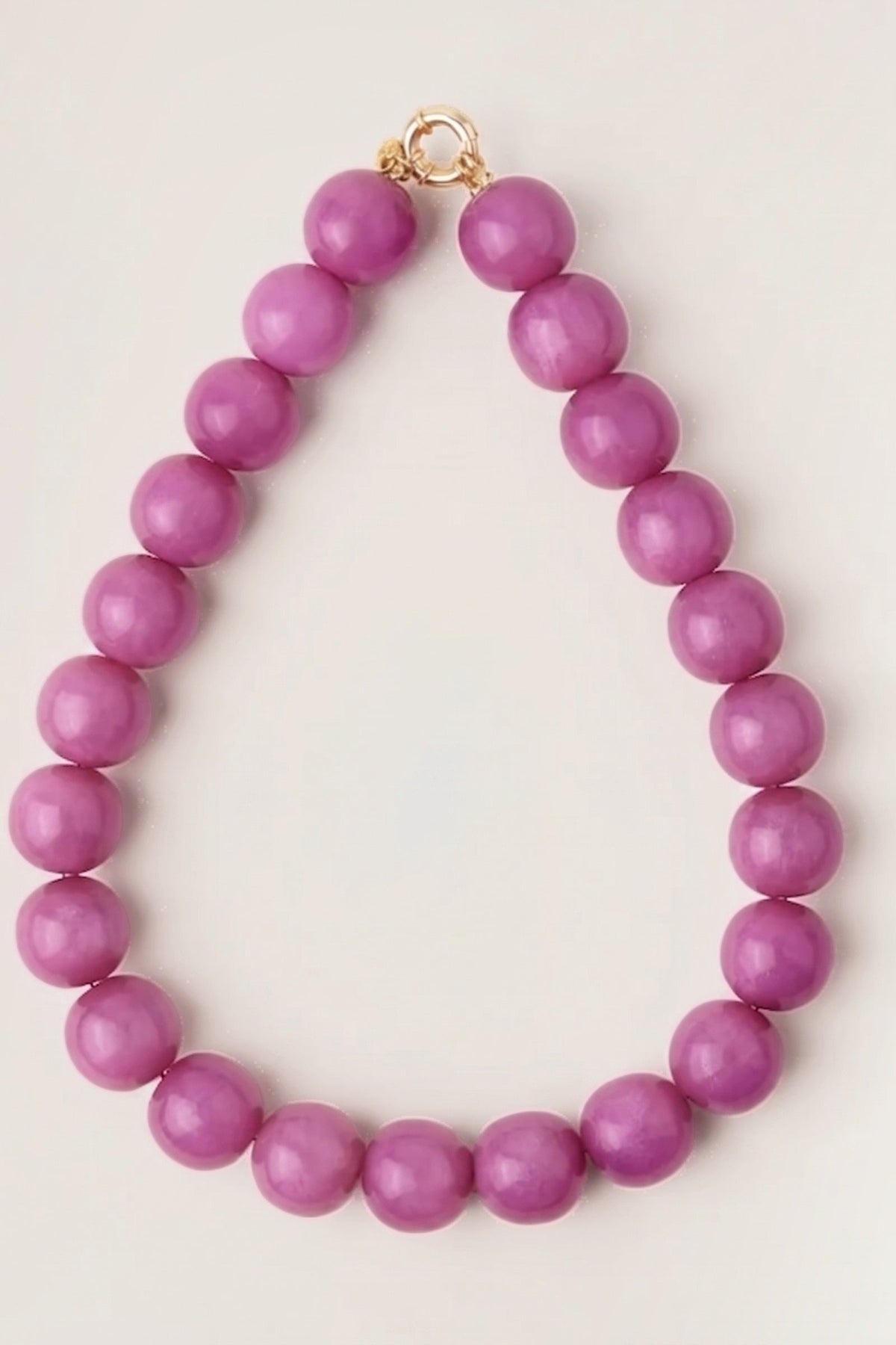 Purple Iris Large Resin Bead Necklace on a cream background
