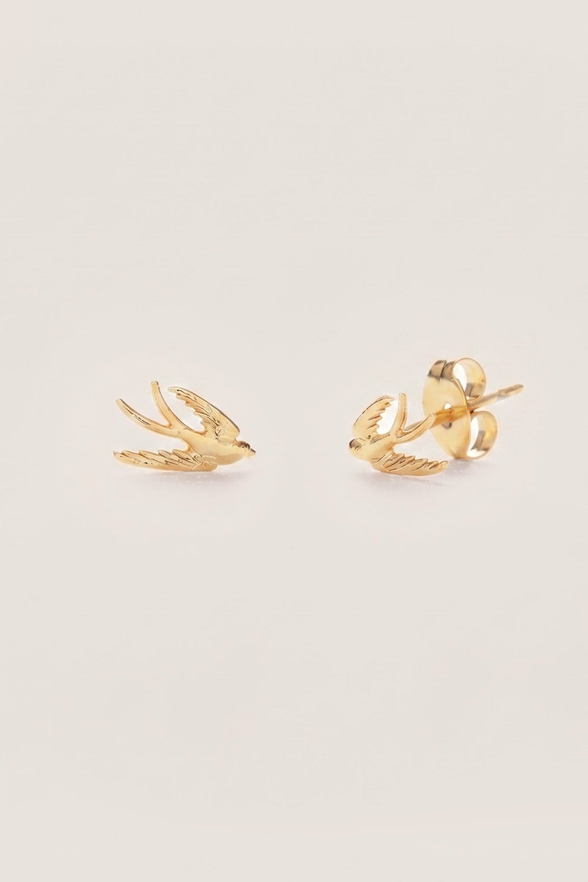 Swallow Bird Stud Earrings on a cream background
