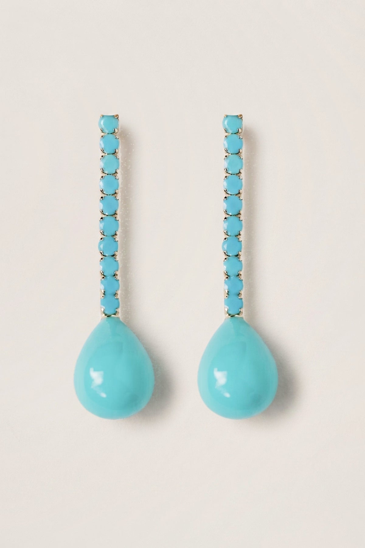 Turquoise Swingy Statement Earrings on a cream background