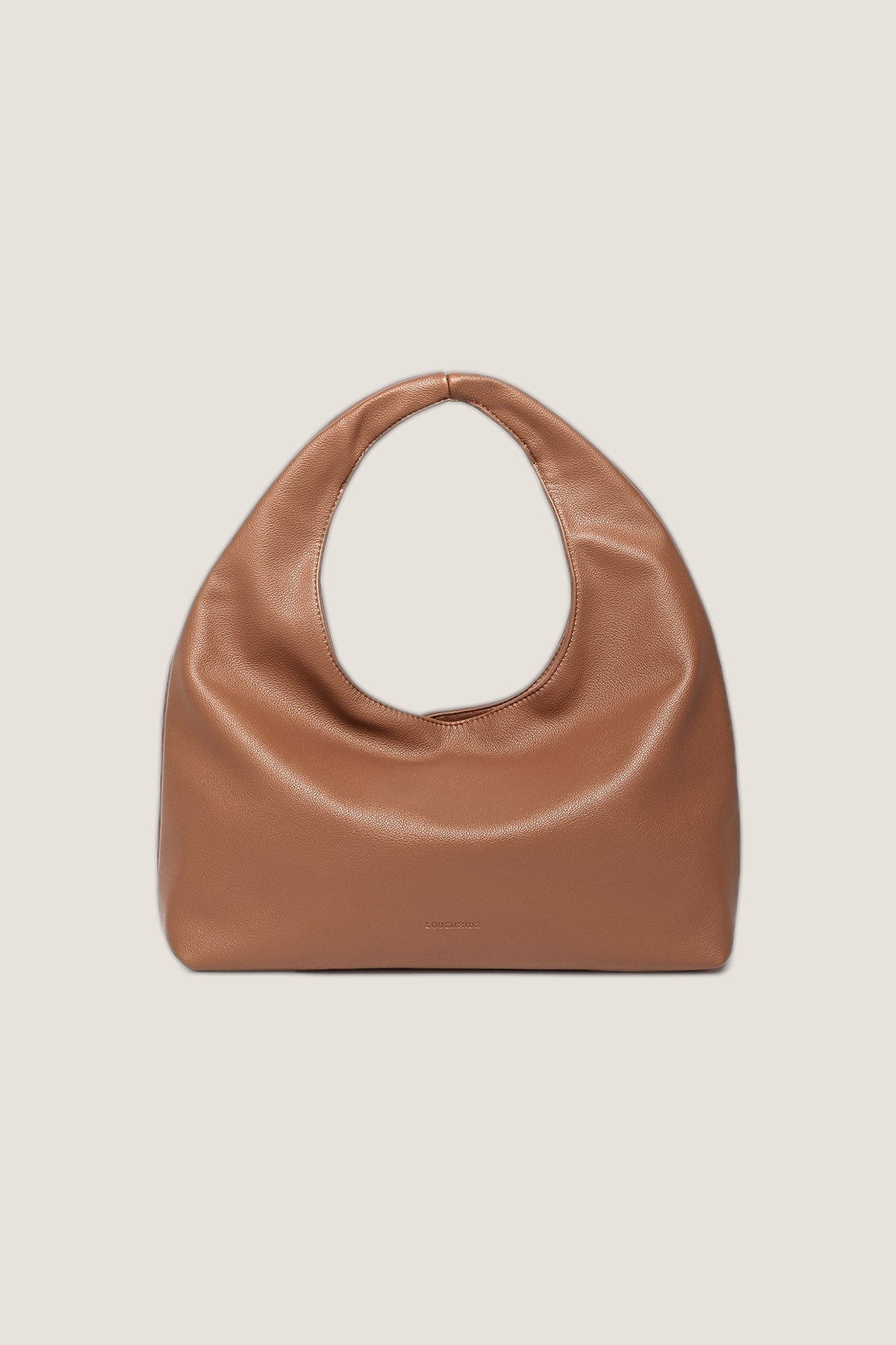 Monaco Toffee Shoulder Bag, a slouchy toffee brown vegan leather hobo with a rounded handle, front view on a warm greige backdrop.