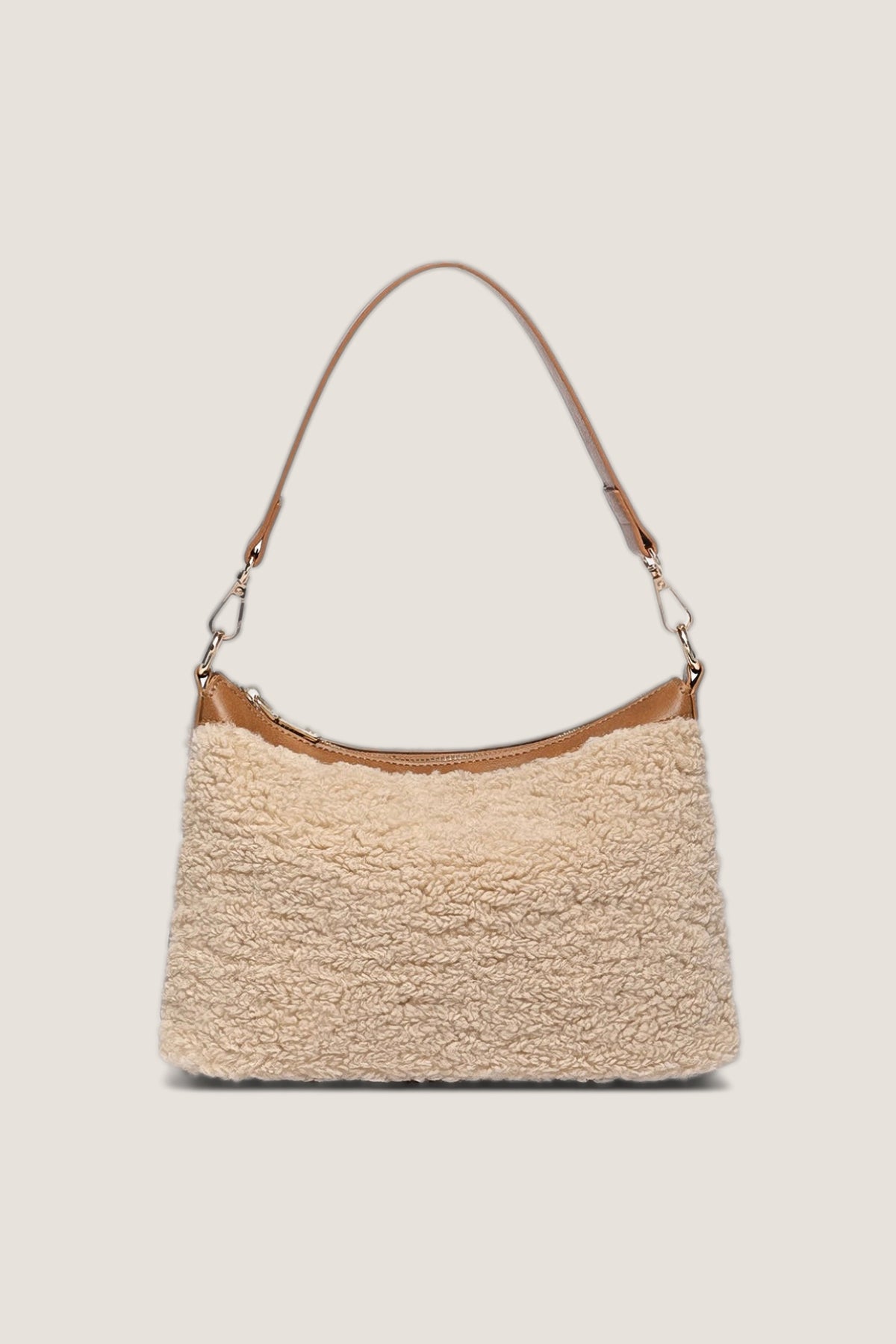 Beige Aspen Shoulder Bag in cream faux shearling with tan vegan leather trim and light gold hardware, front view on a warm greige backdrop.